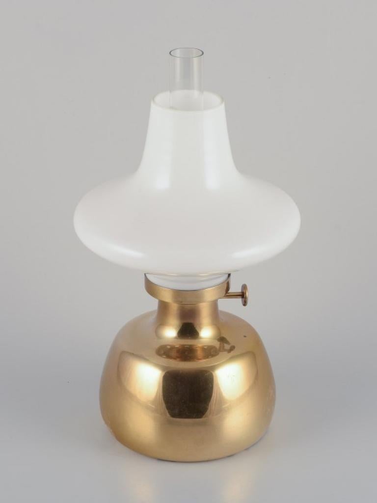 Henning Koppel for Louis Poulsen, Denmark. 
Petronella oil lamp in brass with opal glass shade.
Designed in 1961.
In perfect condition.
Dimensions: H 32.0 cm. x D 17.0 cm.

