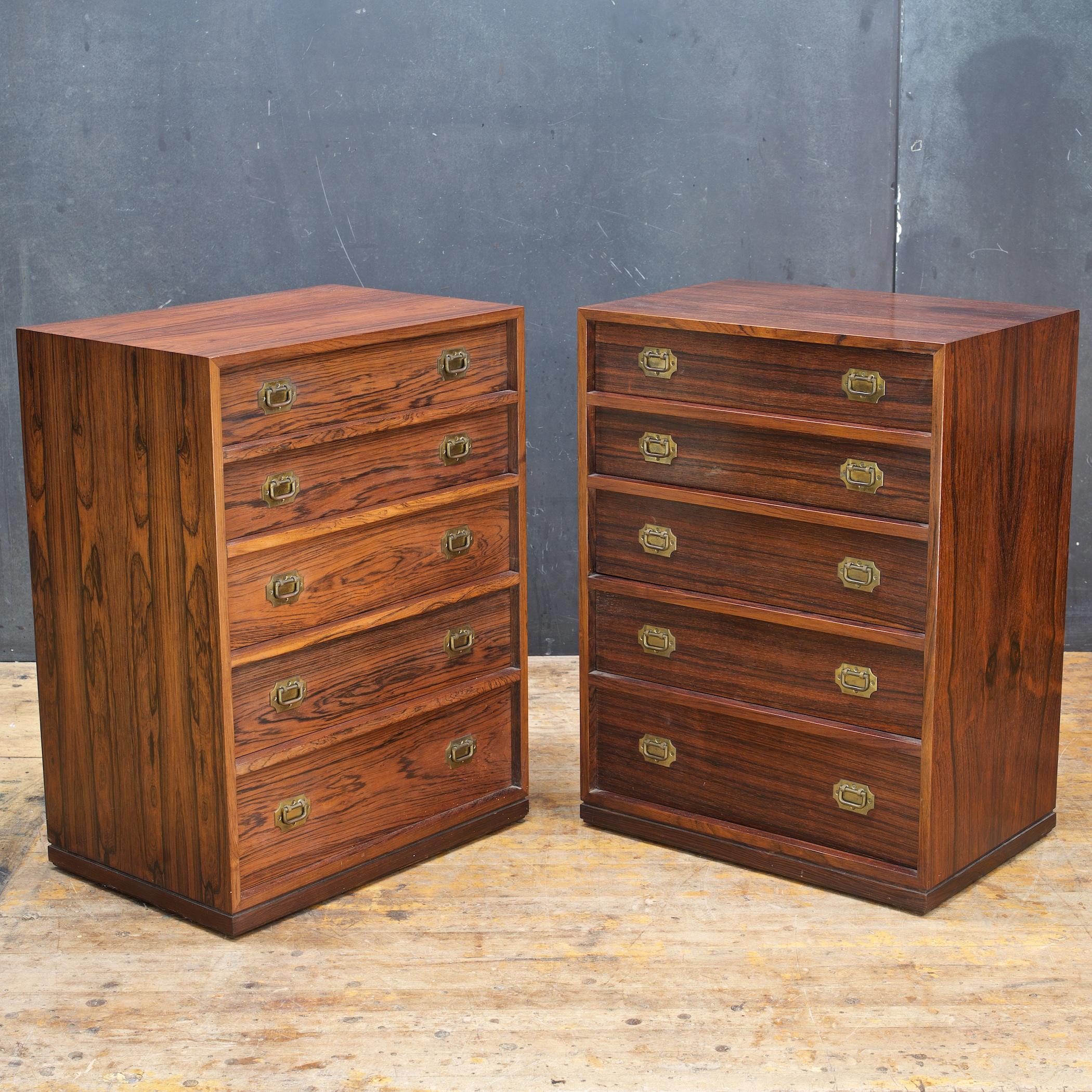 A beautiful pair of petite rosewood campaign style jewelry chests or nightstands designed by Henning Korch for Silkeborge Mobelfabrik. Each with five drawers, interiors are made of mahogany with brass pulls.

These can also be sold separately upon