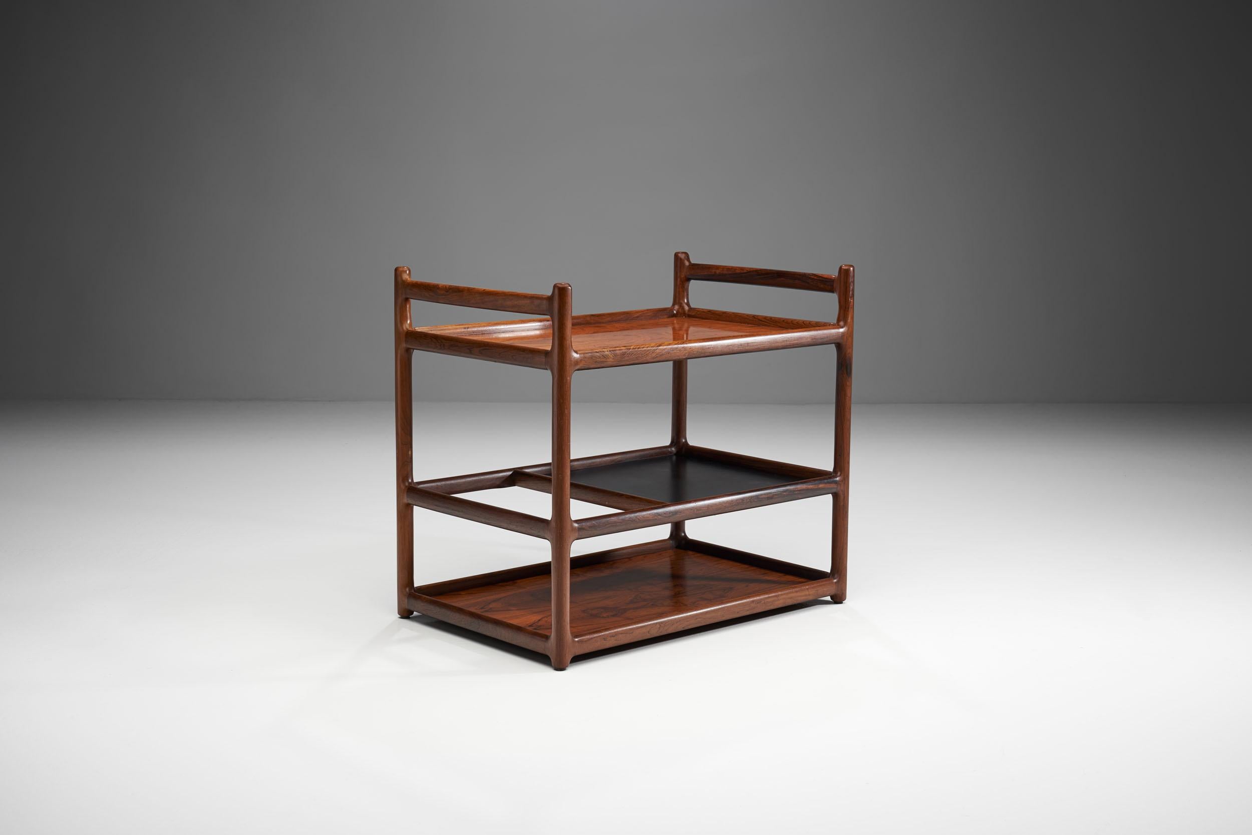 This serving cart is the work of Danish designer Henning Korch, who mainly designed tables and cabinets, prioritising the natural beauty of wood. 

Korch, unlike most Danish designers, did not create seating, instead he perfected his craft