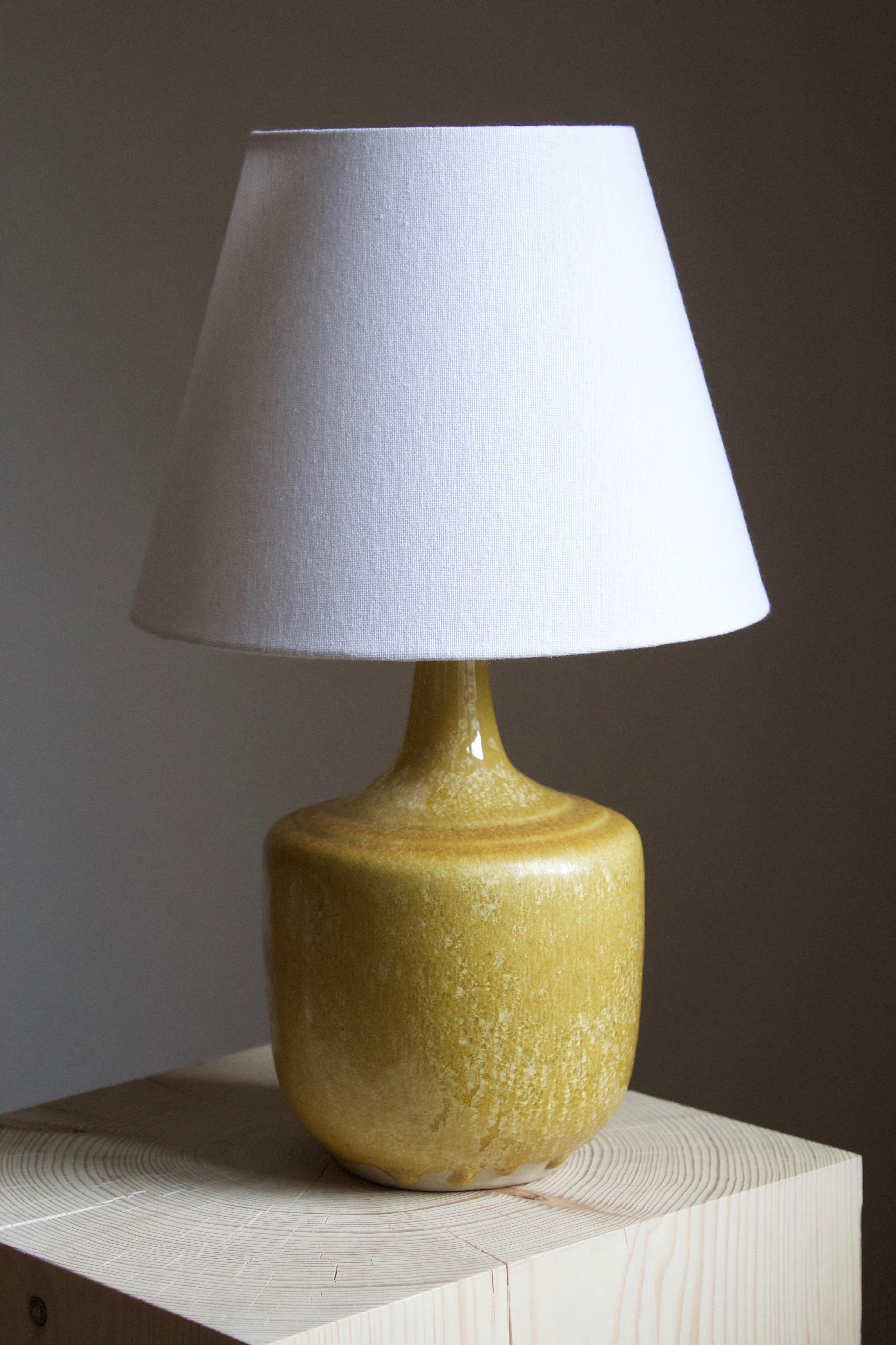 A table lamp, by Henning Nilsson. In highly artistic yellow glazed stoneware. Signed and dated 1988.

Sold without lampshade. Stated dimensions exclude the lampshade. Sold without lampshade.