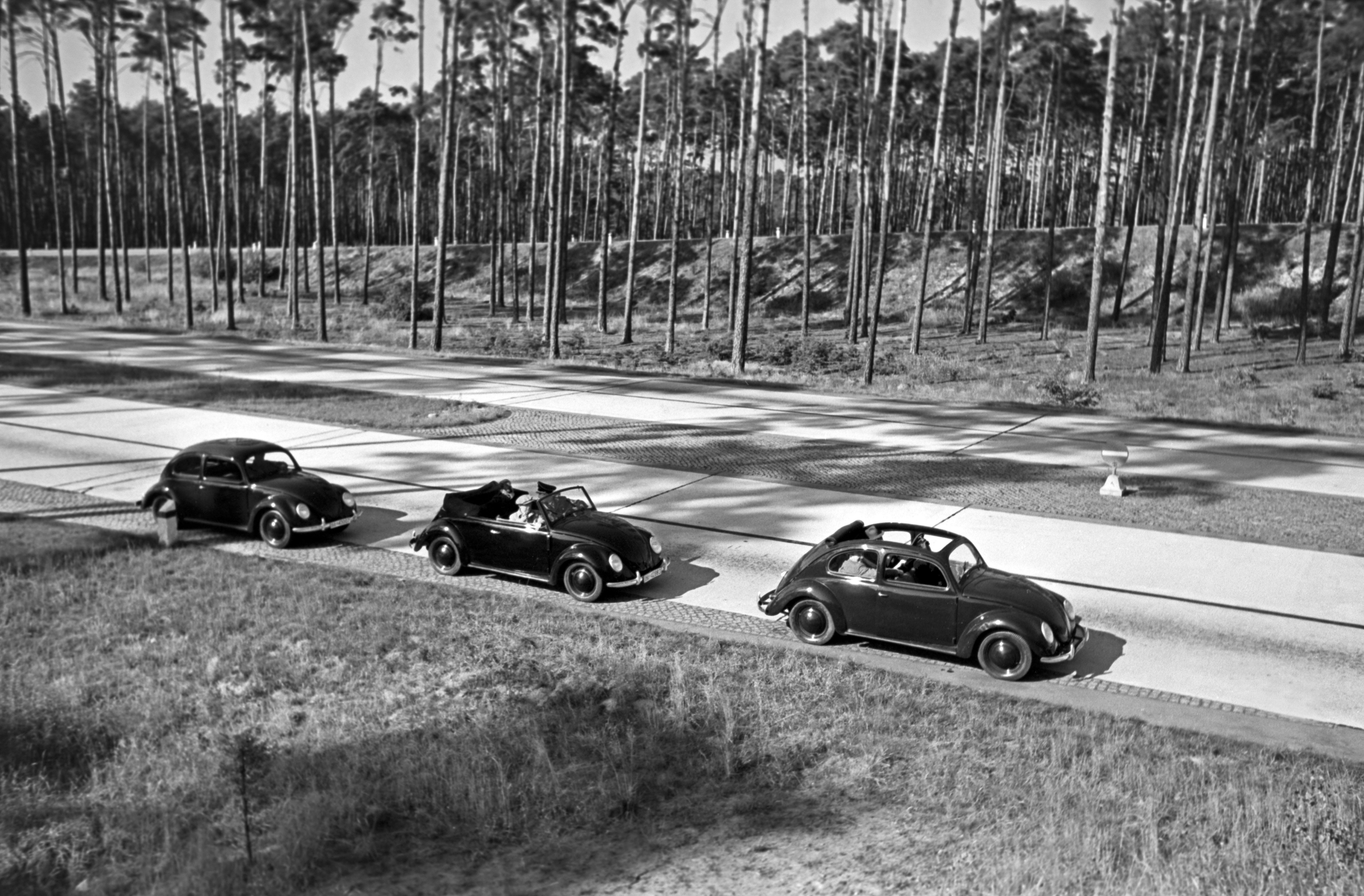 Henning Nolte Black and White Photograph - Three models of the Volkswagen beetle driving, Germany 1938 Printed Later 