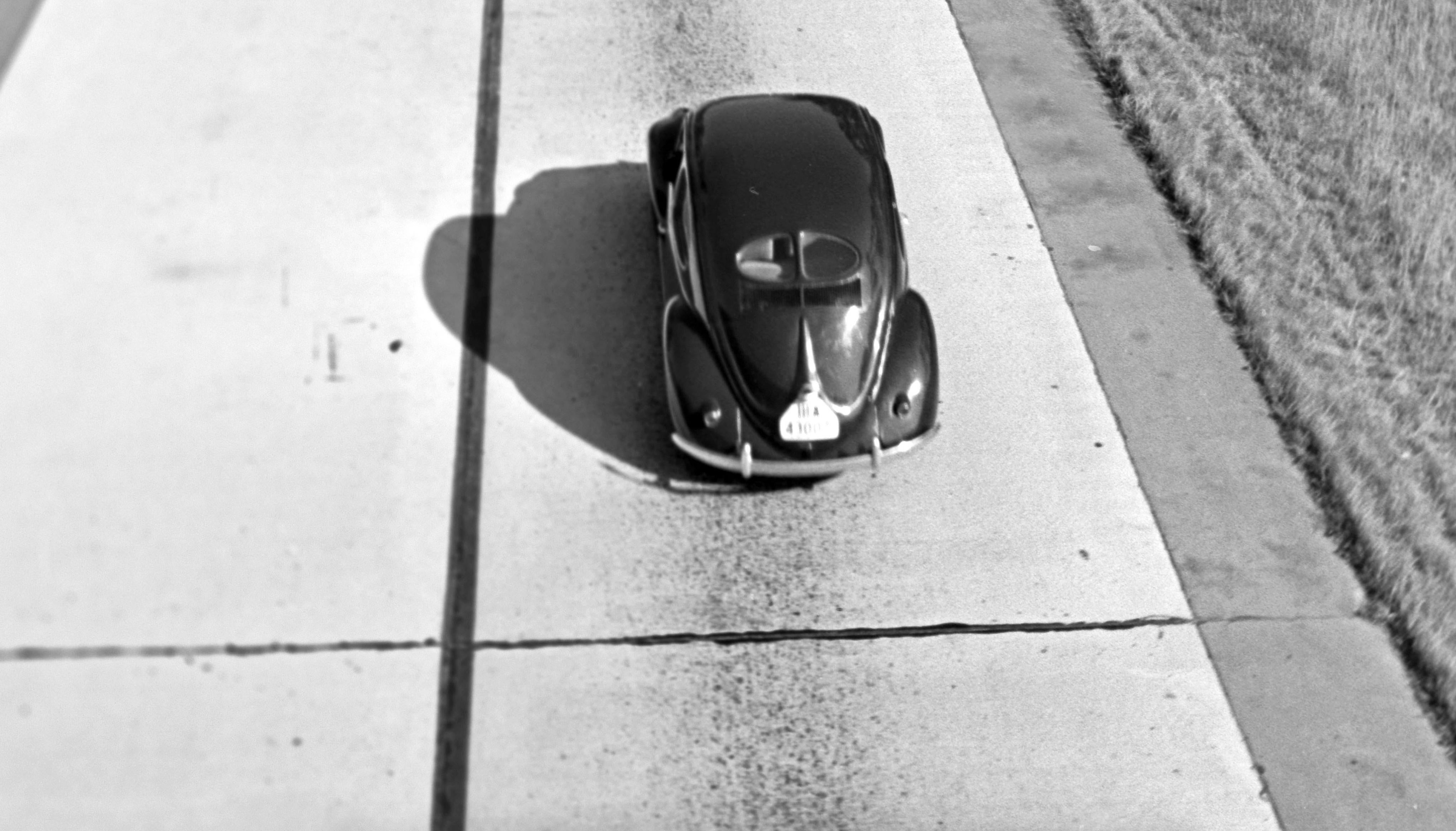 Three Volkswagen beetle on street, Germany 1938 Printed Later  - Photograph by Henning Nolte