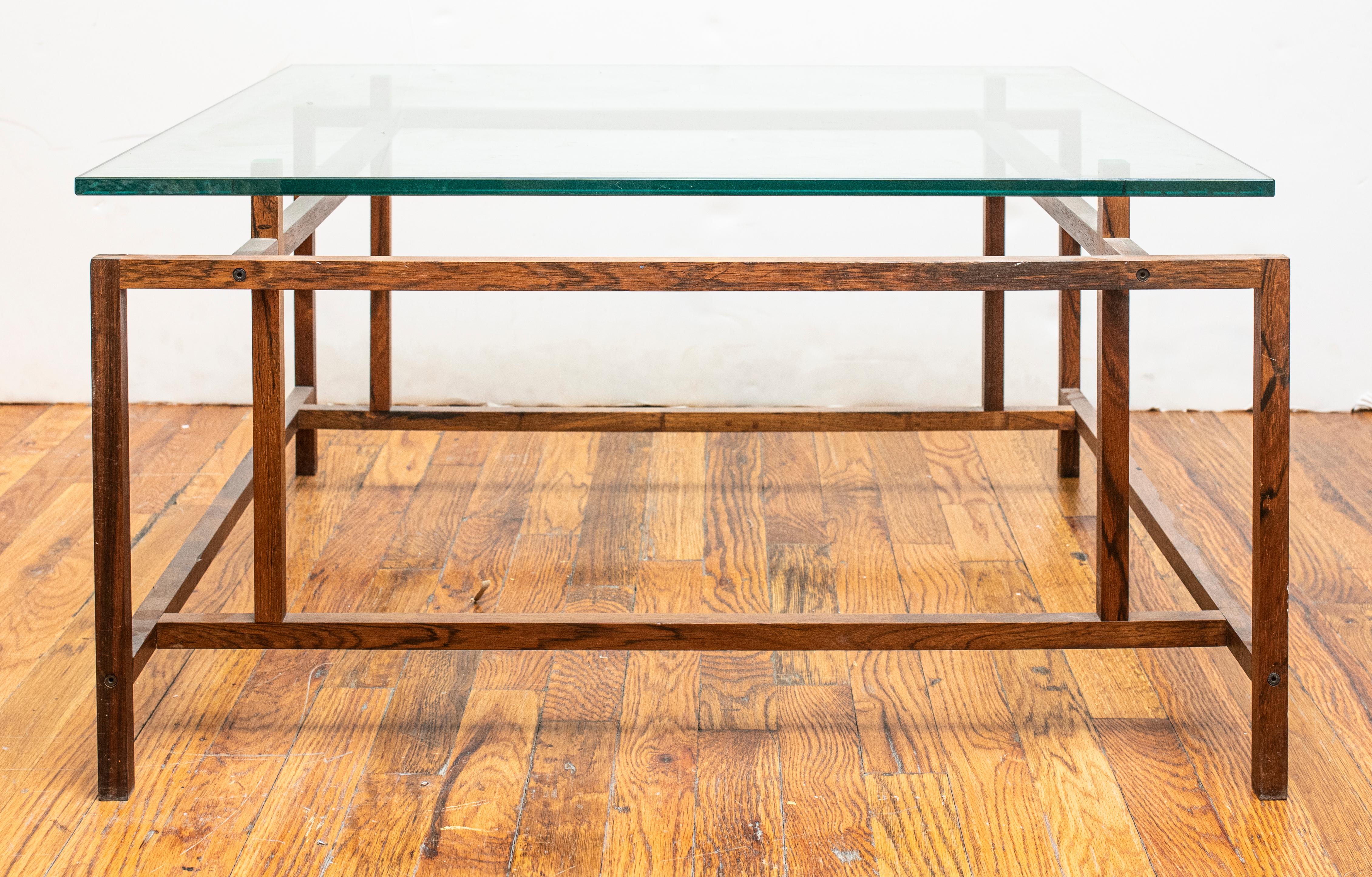 Henning Norgaard for Komfort Mobler Danish Mid-Century Modern coffee table with constructivist style teak wood base and square glass top. 16.5
