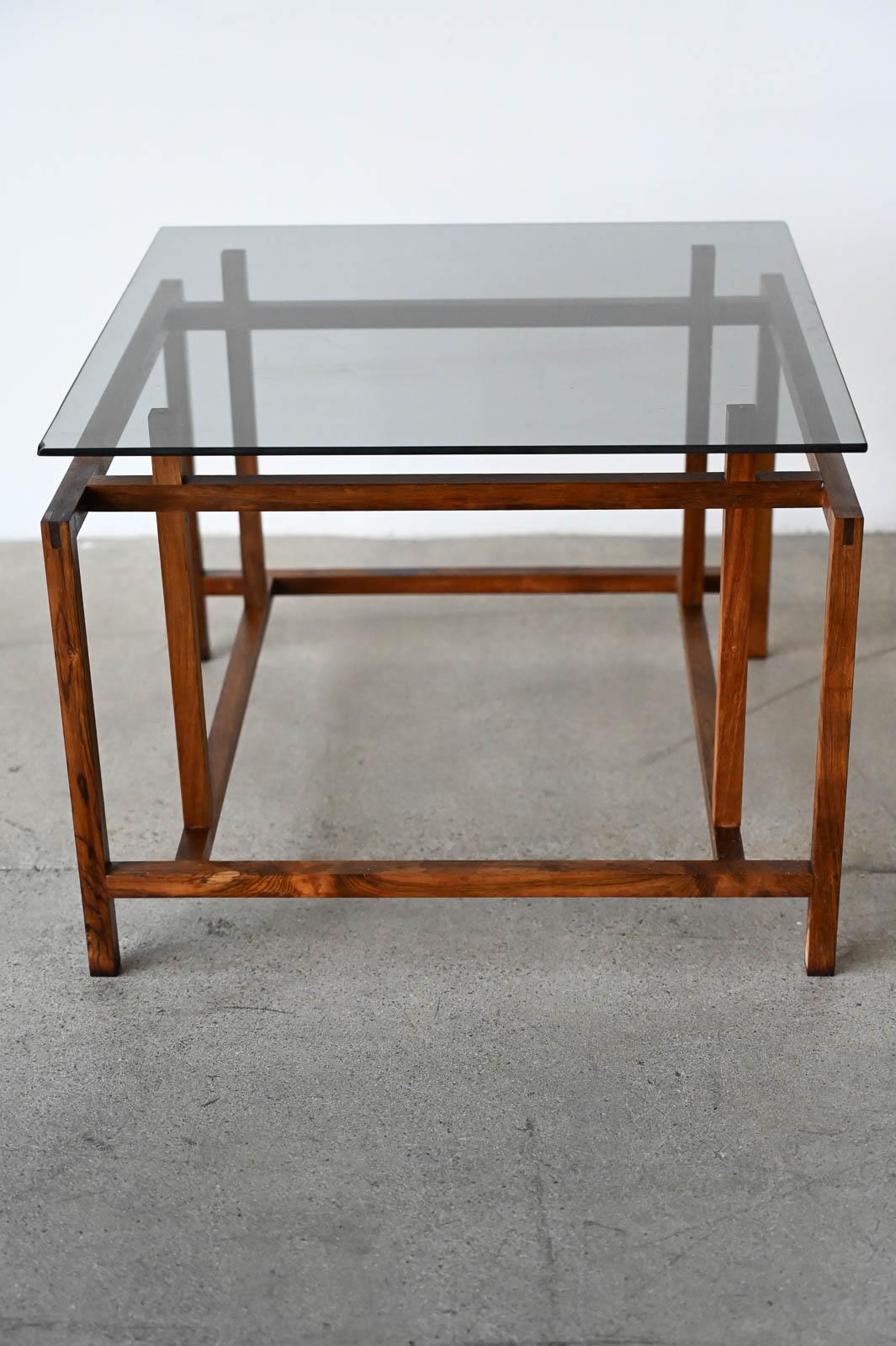 Henning Norgaard for Komfort Rosewood and Smoked Glass Side Table, ca. 1960.  Small rosewood and smoked glass square side table with floating glass top on a delicate rosewood base.  

Measures 19.5