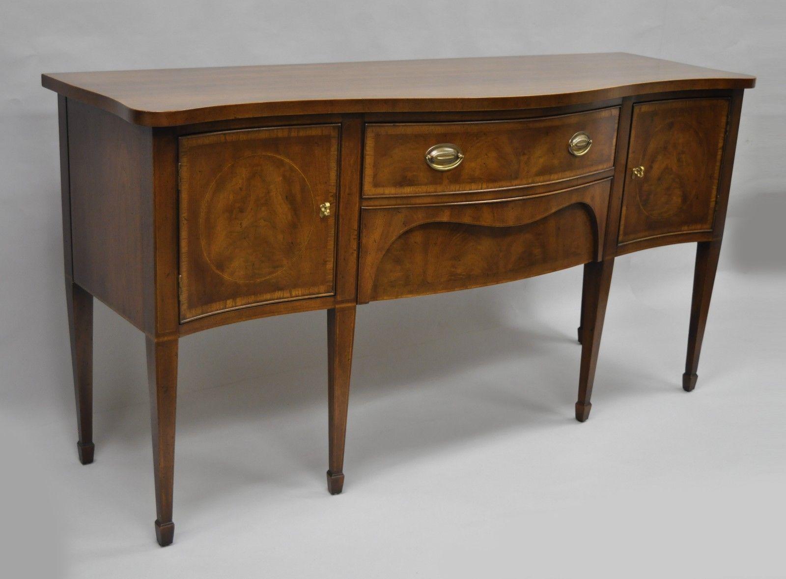 Henredon 18th century portfolio banded mahogany sideboard sideboard. Item details long slender tapered legs, beautiful wood grain, two dovetail constructed drawers, two cabinet doors, banded bow front, brass hardware, Henredon branding to inner
