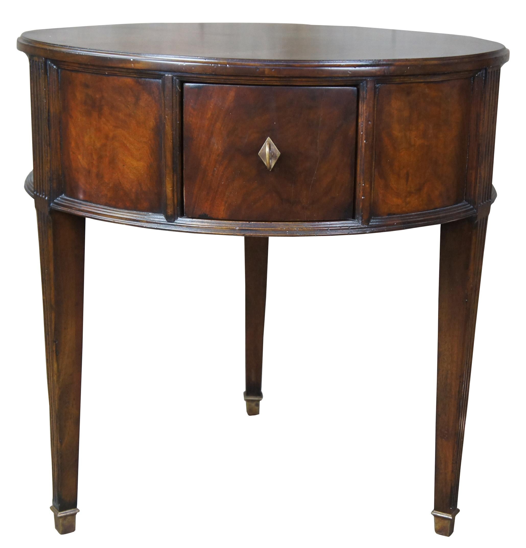 Henredon acquisitions flamed mahogany traditional round burnet drum side table

Traditional inspired drum table by Henredon.  The Burnet side table is from the Acquisitions Collection.  Flamed mahogany with 3 drawers,  tapered and fluted legs over