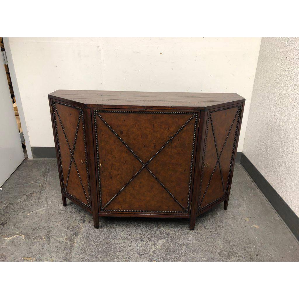 An Acquisitions Honore credenza by Henredon. A Transitional design, the doors are leather wrapped doors, the finish is Avigon on Leather. The construction behind the doors are three adjustable shelves. The wood is mahogany solids with veneers. Made