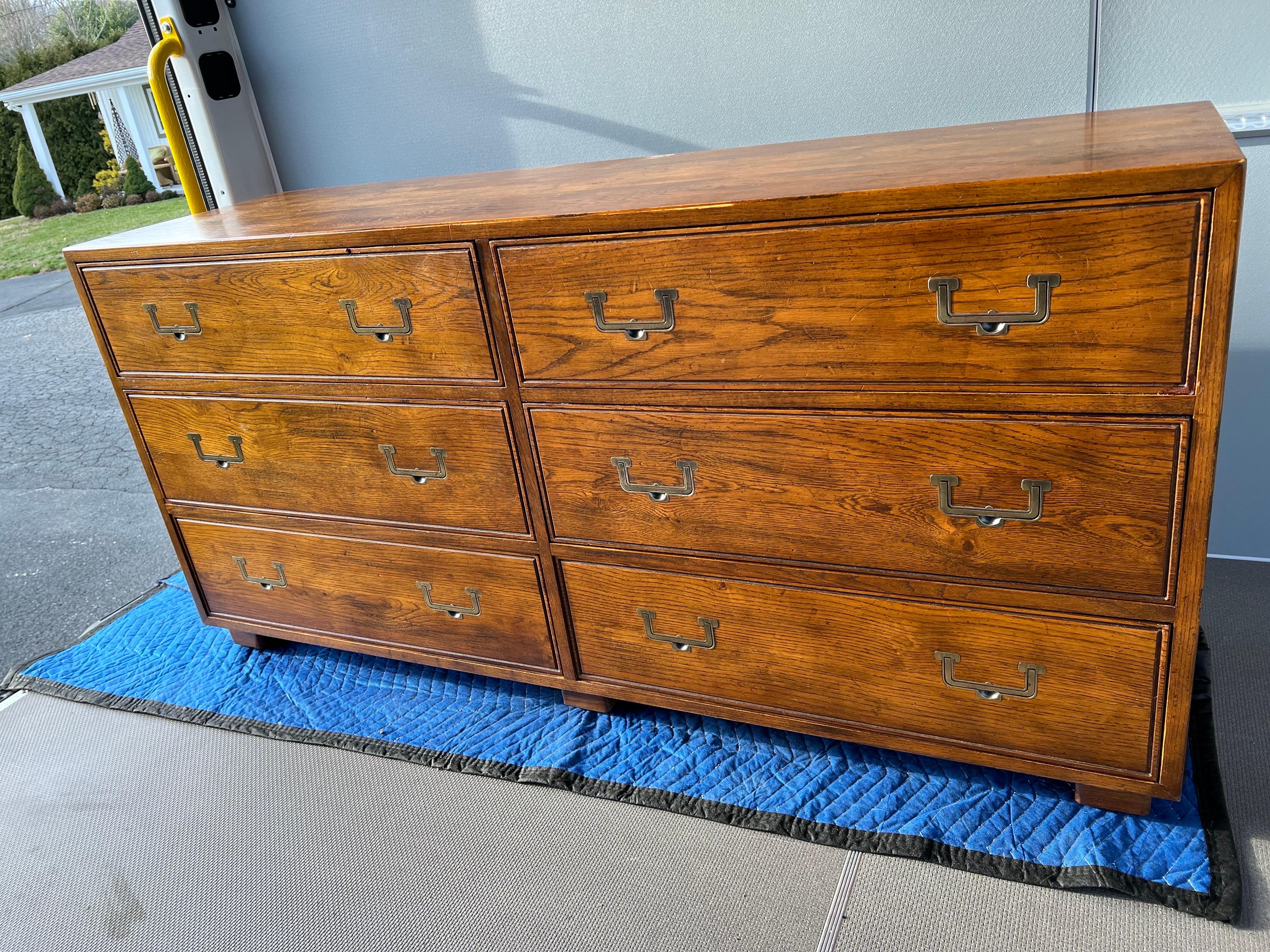 Henredon Artefacts Campaign dresser. Classic oak wood with recessed brass brass handles . Solid wooden construction . Some drawers have separators between drawers.
