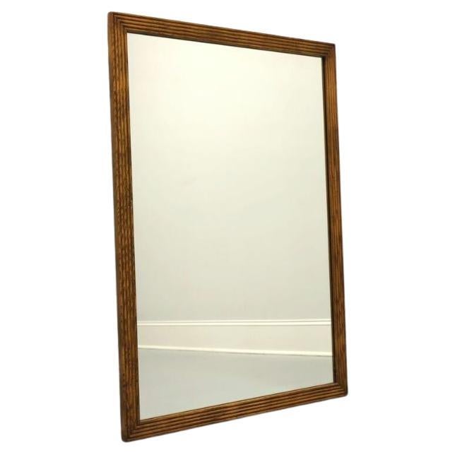 A campaign style wall mirror by Henredon, from their Artefacts line. Made in North Carolina, USA, circa 1980's. Made from mirror glass with ribbed pecan frame. 

Style #: 7500-04

Measures: 34.25 W 1 D 47.25 H

Excellent condition with signs of very