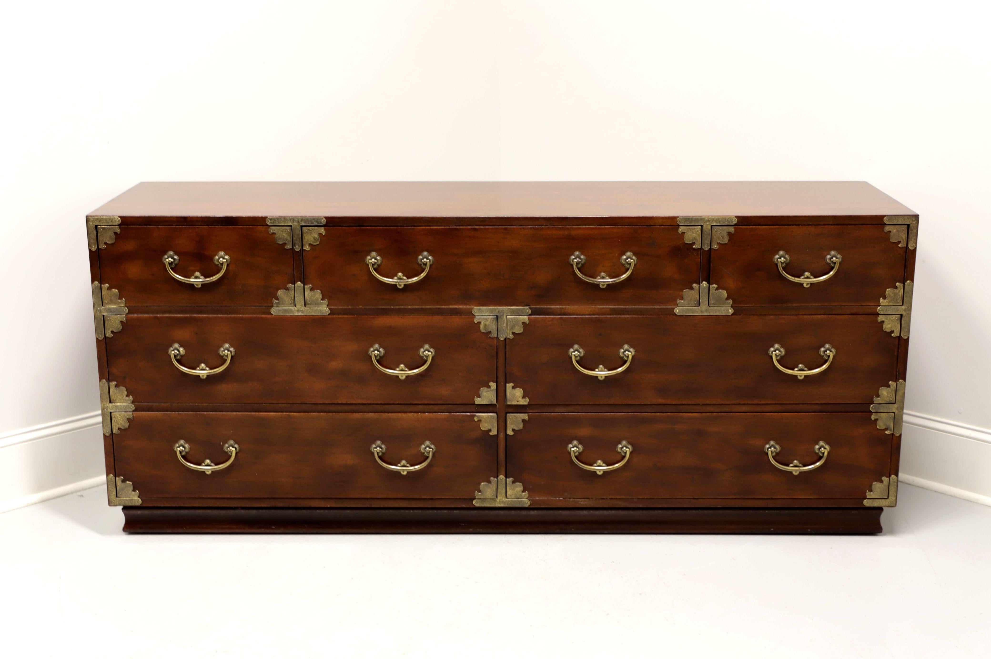A dresser in the Japanese Tansu Campaign style by Henredon. Walnut with brass hardware and accents. Features seven various size dovetail drawers, top center has removable dividers and a jewelry tray with lower two drawers having removable dividers.