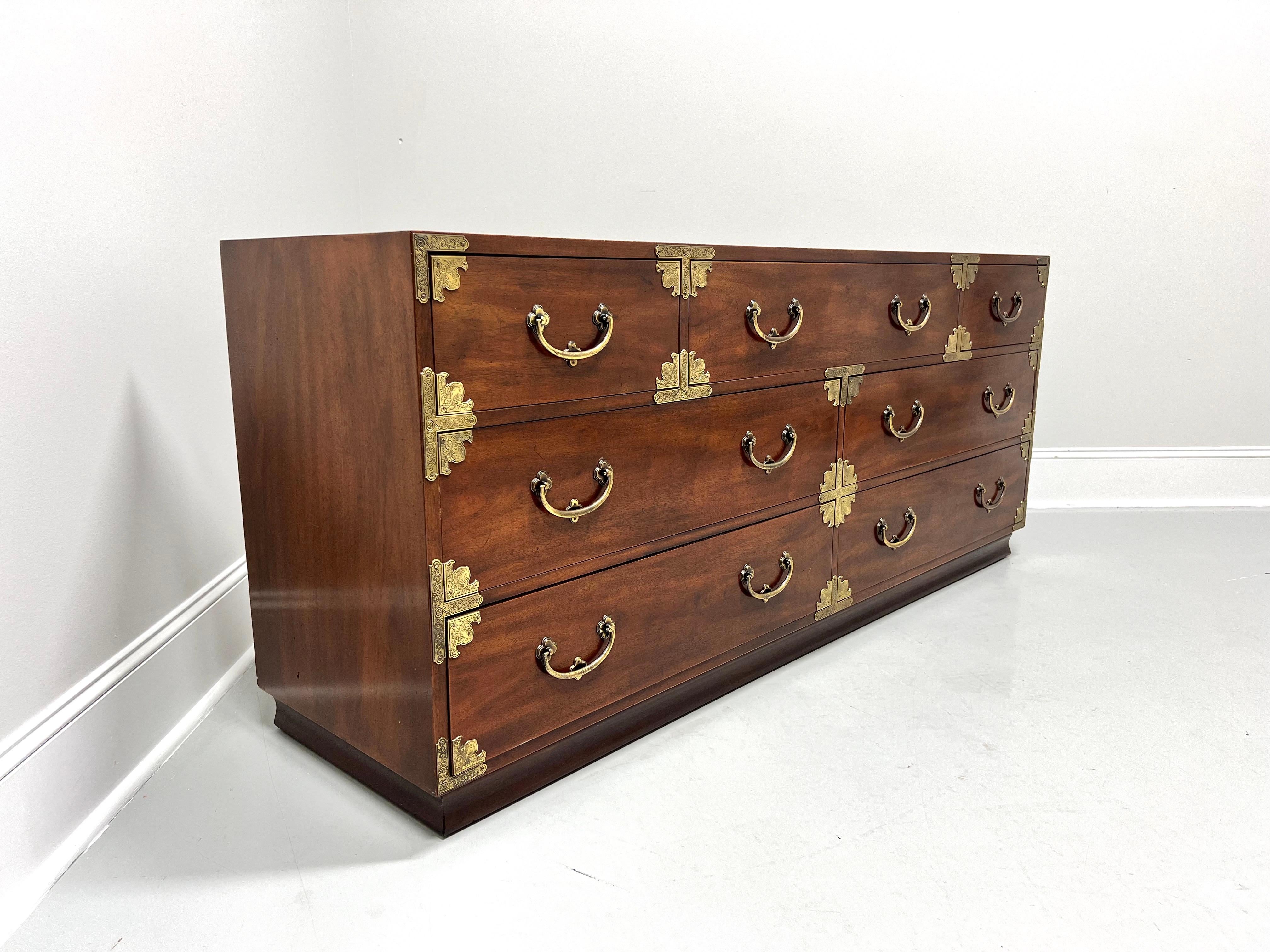 A dresser in the Japanese Tansu Campaign style by Henredon. Mahogany with smooth surface top, brass hardware & accents, and a solid base. Features seven various size dovetail drawers, top center has removable dividers and a jewelry tray with lower