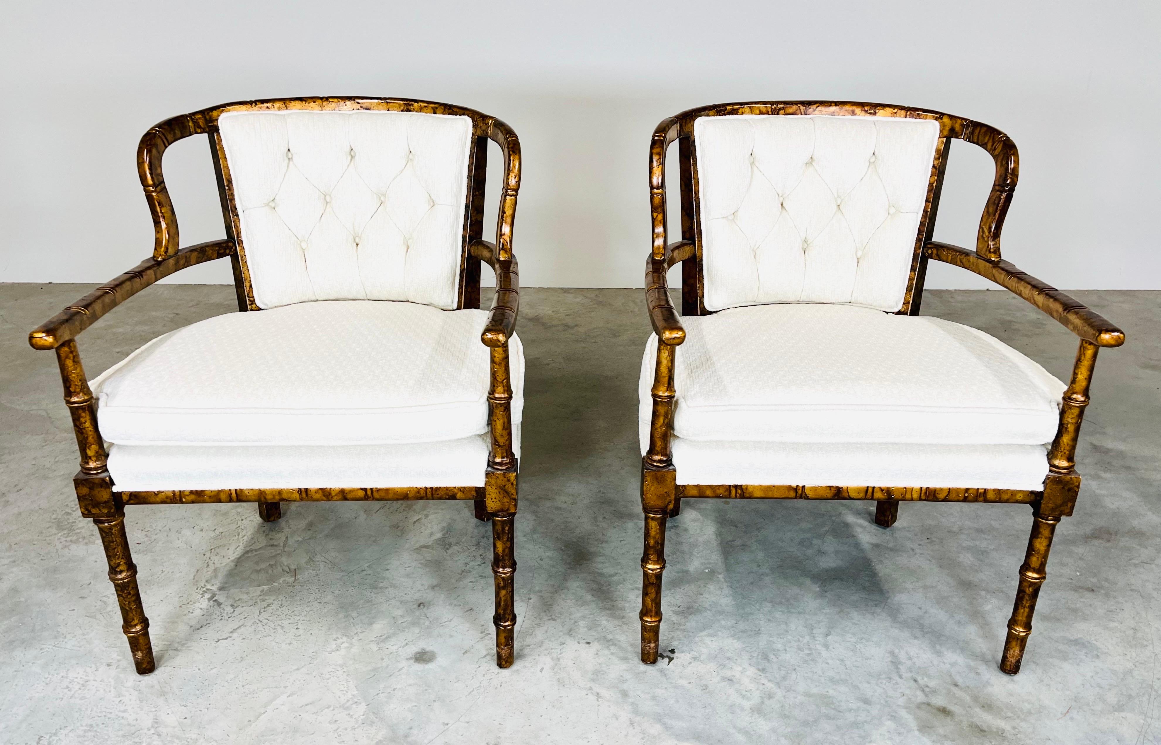 Faux bamboo with tortoise finish armchairs attributed to Henredon having loose notched carat cushions with button tufted backs, interesting open wings & arm design. 
In outstanding vintage condition having fresh plush cotton/poly upholstery with