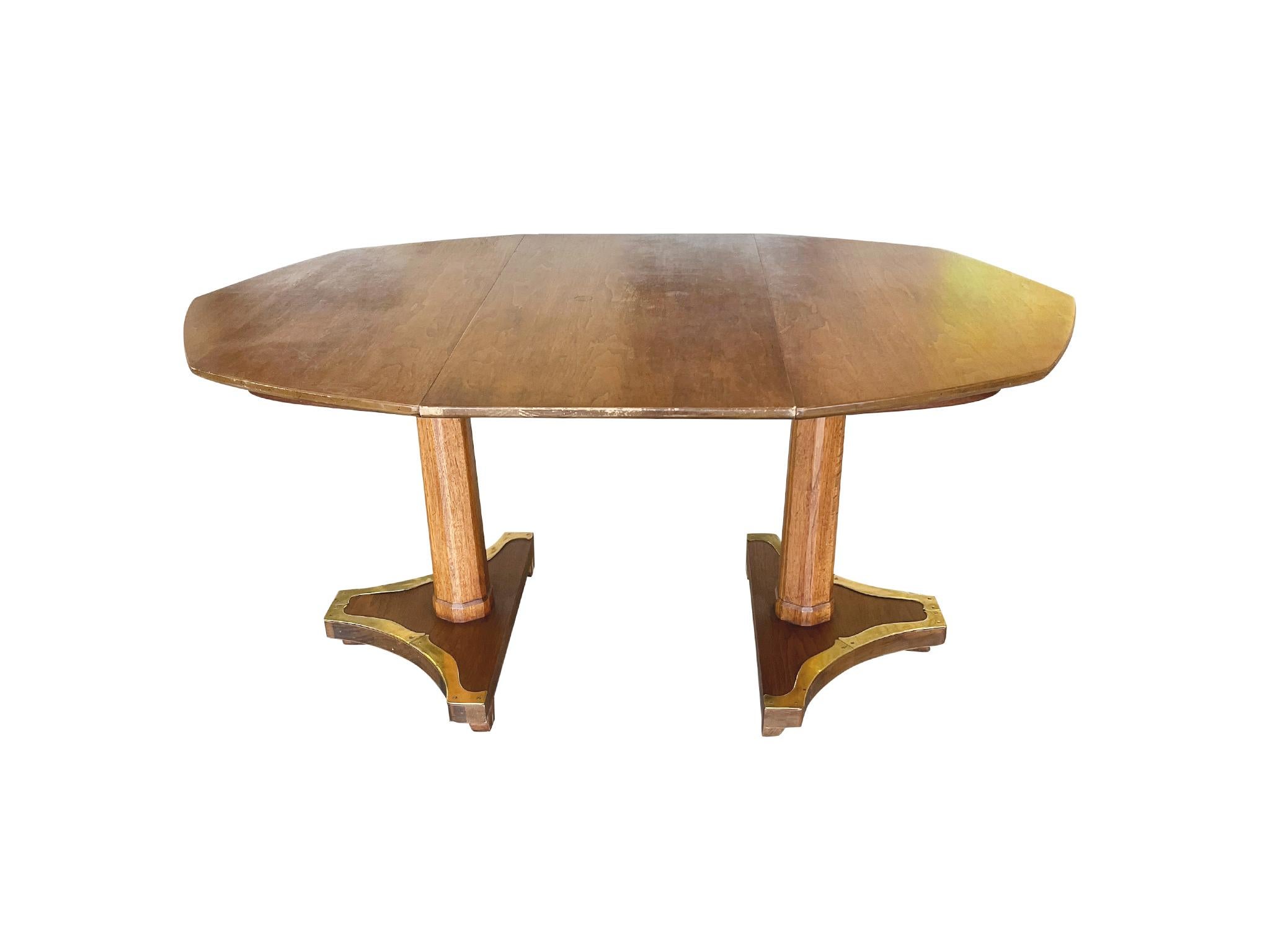 Designed in the Biedermeier style, this 20th Century octagonal extending table was made by Henredon. It is fruitwood and oak with brass mounting and two pedestal legs. It comes fitted with one leaf, which extends the table to longer rectangular