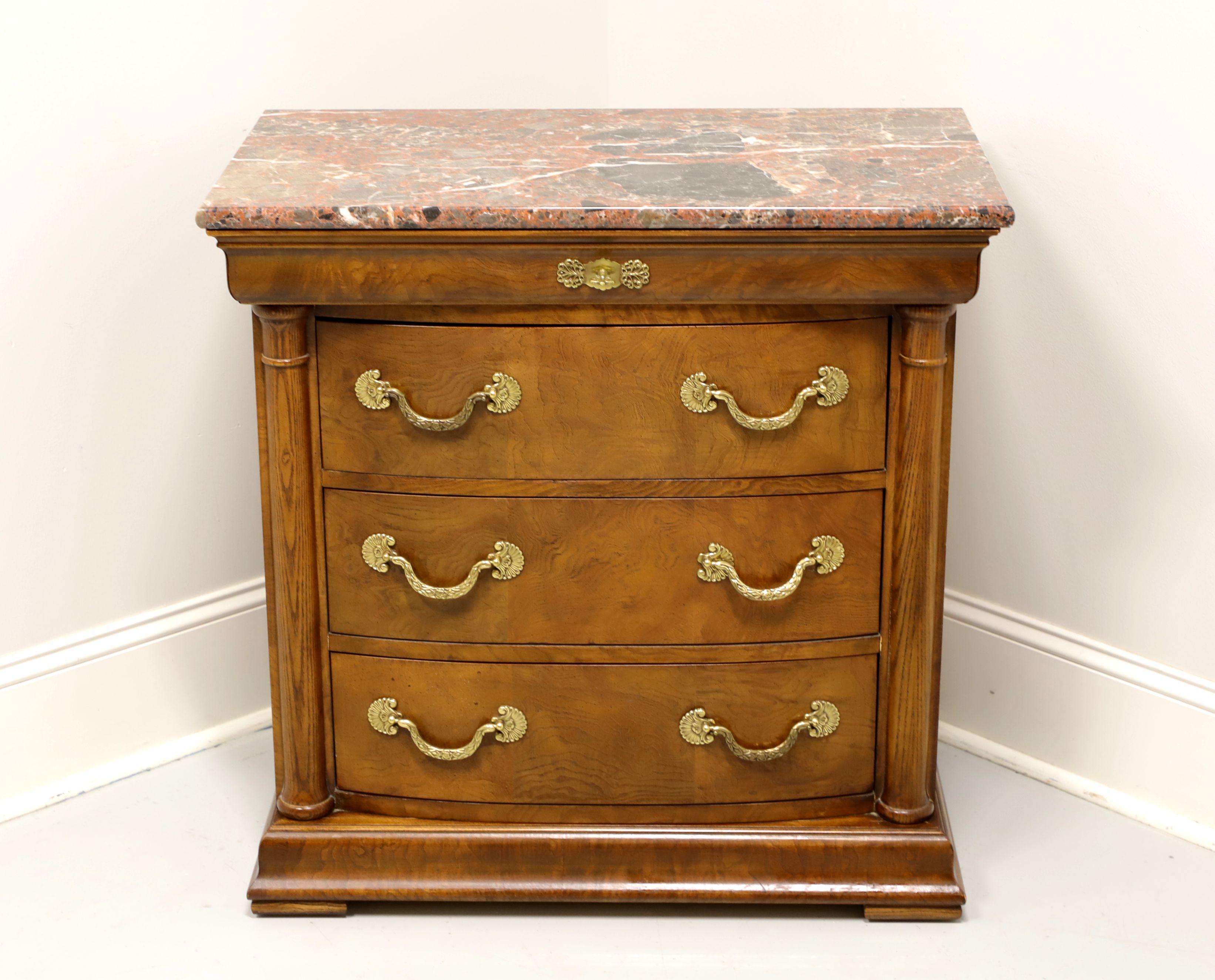 A bedside chest in the neoclassical style by Henredon, of Morganton, North Carolina, USA. Burl elm with marble top, decorative brass hardware, side columns and pad feet. Features a shallow dovetail drawer blended into the upper moulding with faux