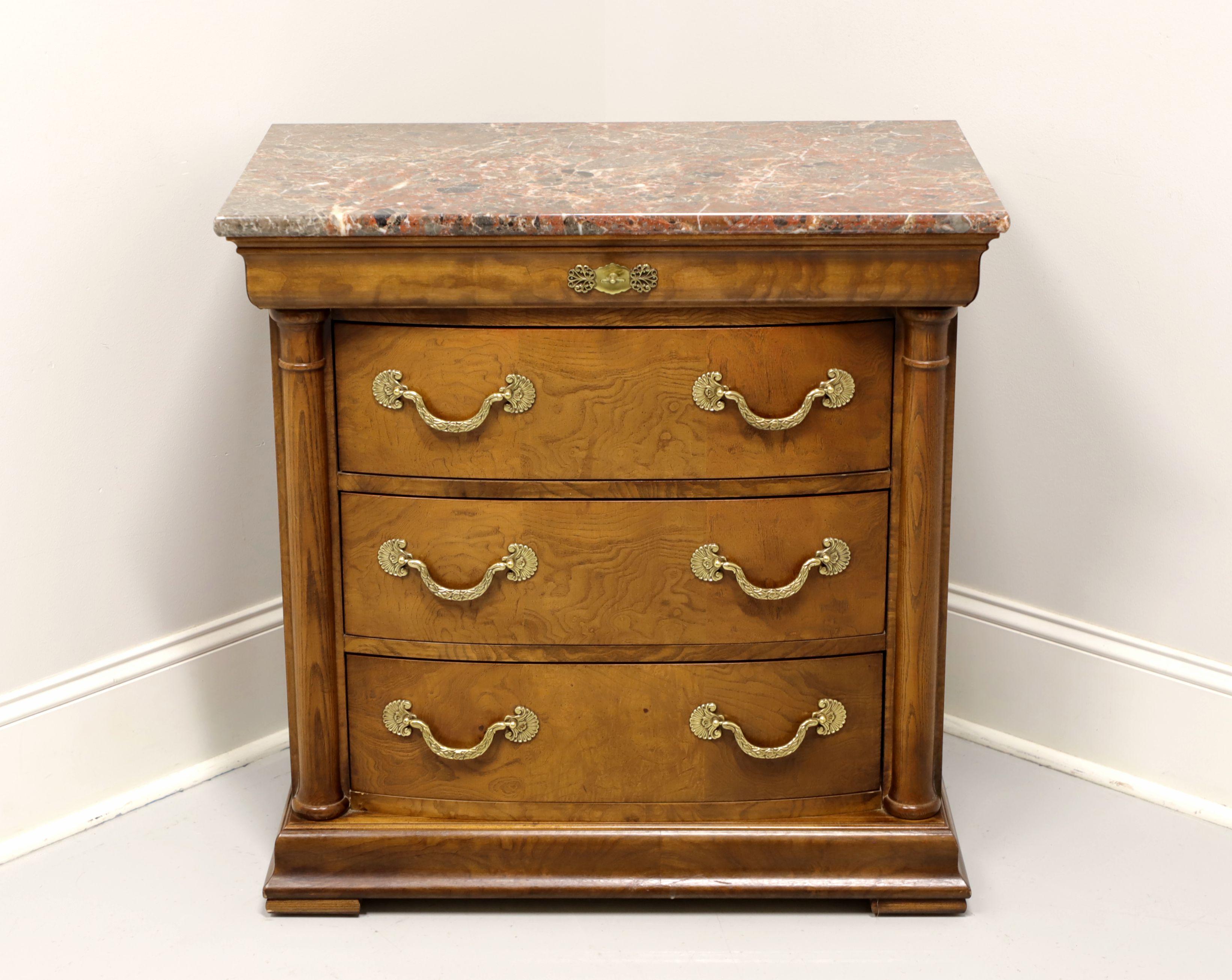 A bedside chest in the Neoclassical style by Henredon, of Morgantown, North Carolina, USA. Burl elm with marble top, decorative brass hardware, side columns and pad feet. Features a shallow dovetail drawer blended into the upper moulding with faux