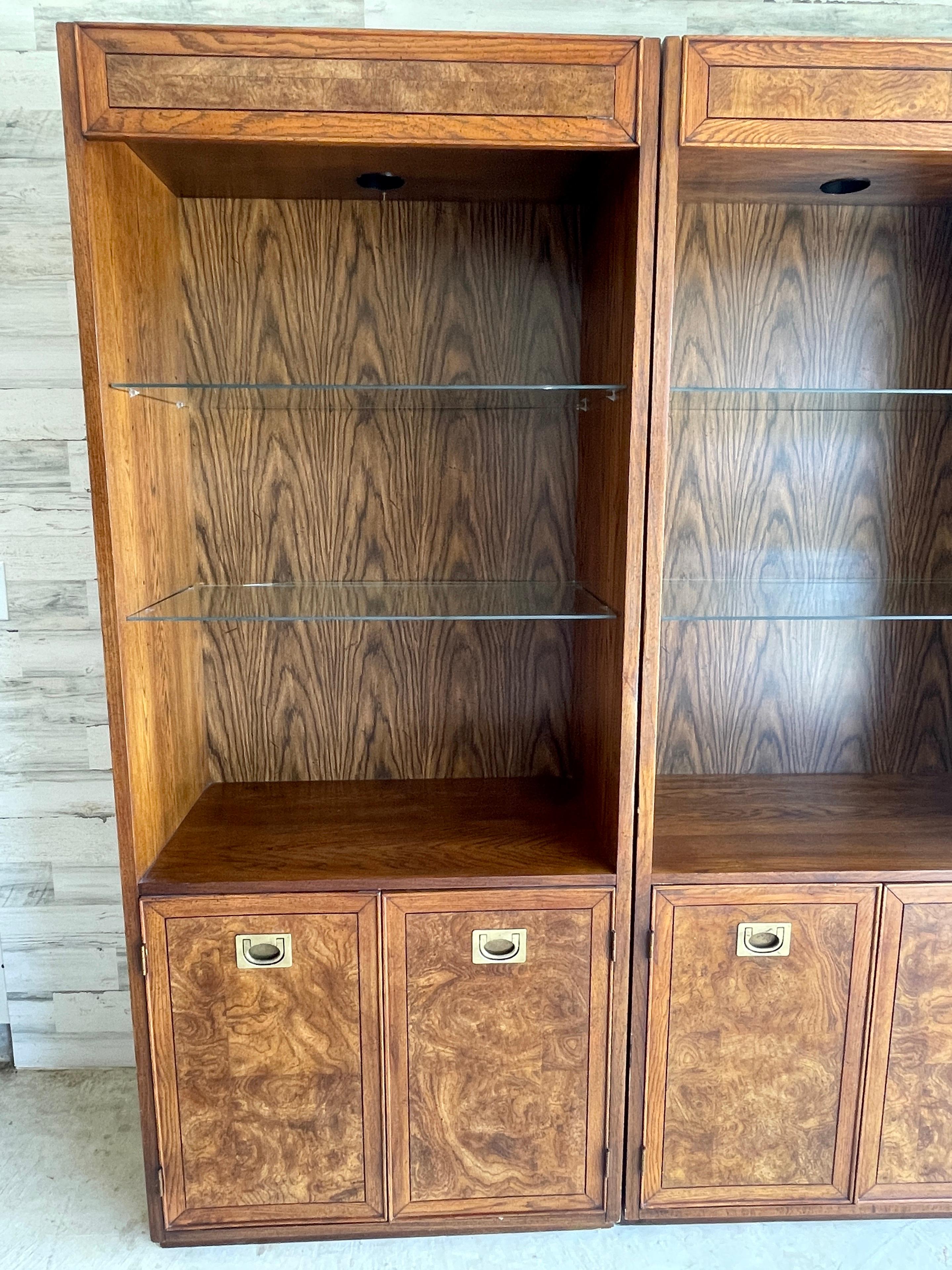 Henredon Burl Wall Unit. 3 separate cabinets that can be used as one wall unit or separately. Glass shelves with a plate groove to display collectible plates with a curio light on the top. Bottom cabinets have shelves for more storage. 