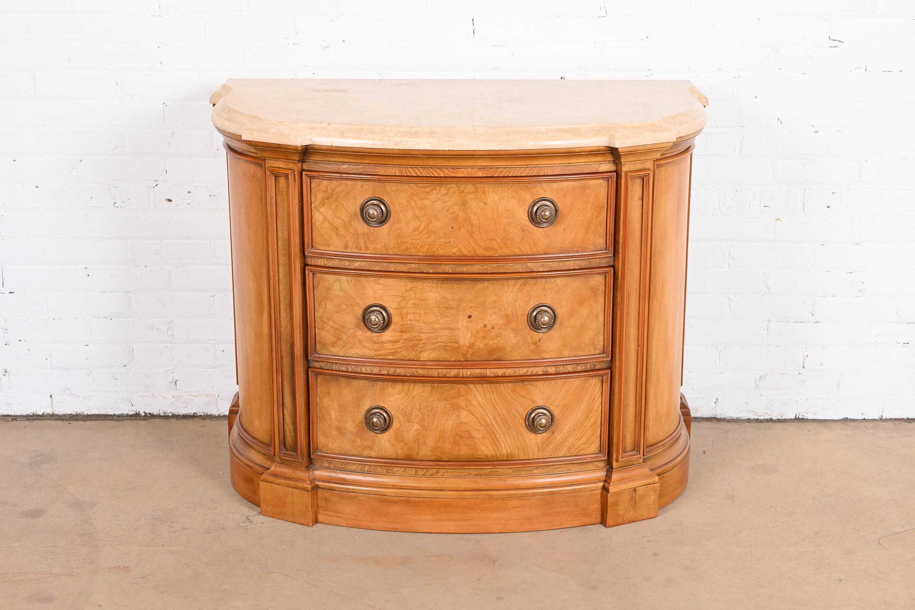 An exceptional Regency style demilune console, commode, or chest of drawers

By Henredon

USA, Circa Late 20th Century

Gorgeous carved burl wood, with beveled marble top and original brass hardware.

Measures: 45
