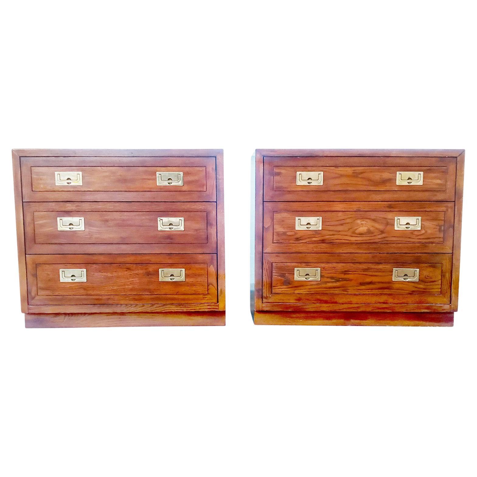 A wonderful pair of small dressers or large nightstands with original satin sheen finish on distressed oak with polished brass handles. Quality construction. Wonderful Campaign styling. The perfect size and style for just the right room.