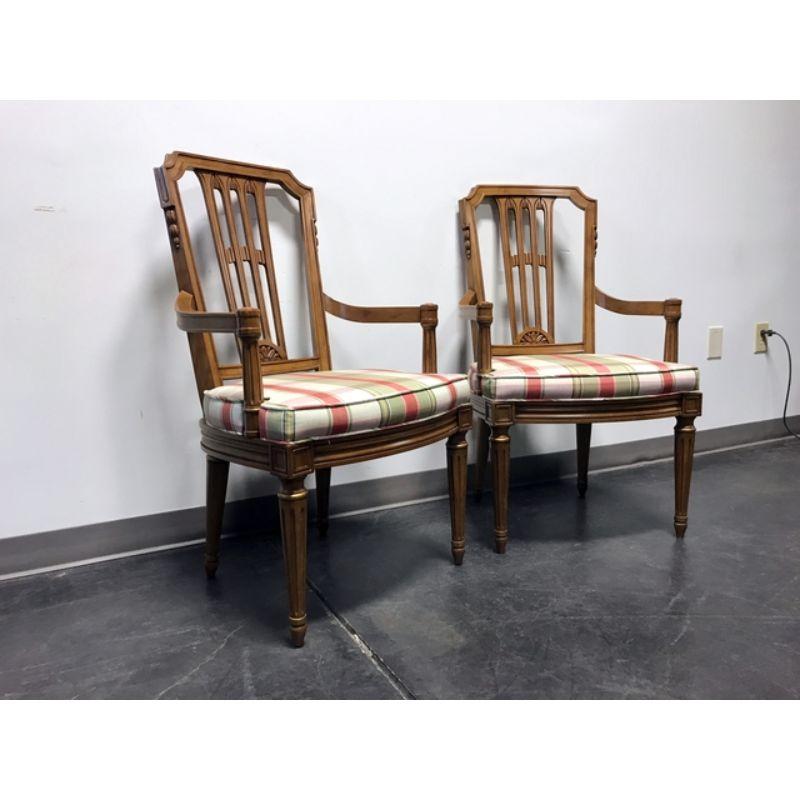 A pair of mid-century Italian Provincial Neoclassical Style dining armchairs by Henredon, from their Capri line. Solid wood with carved backsplat, striped fabric upholstered seat and fluted legs. Made in North Carolina, USA, in the mid 20th