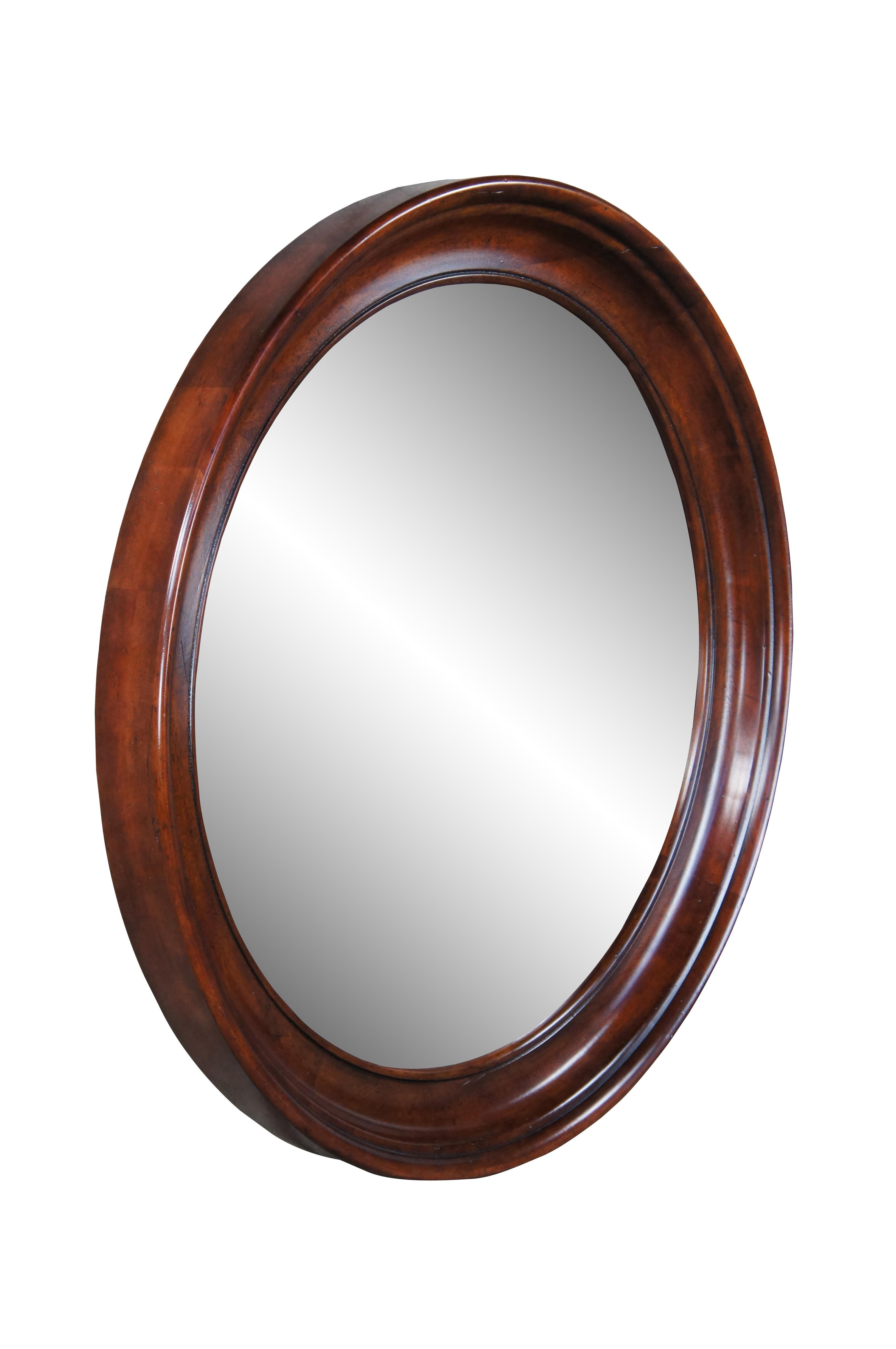 Vintage Henredon cavalier aged cherry round beveled bullseye style vanity or hall mirror.  Includes hanging bracket.  6200 - 04 - 93, 350498, 5492916.  Made in Columbia.

Dimensions:
42