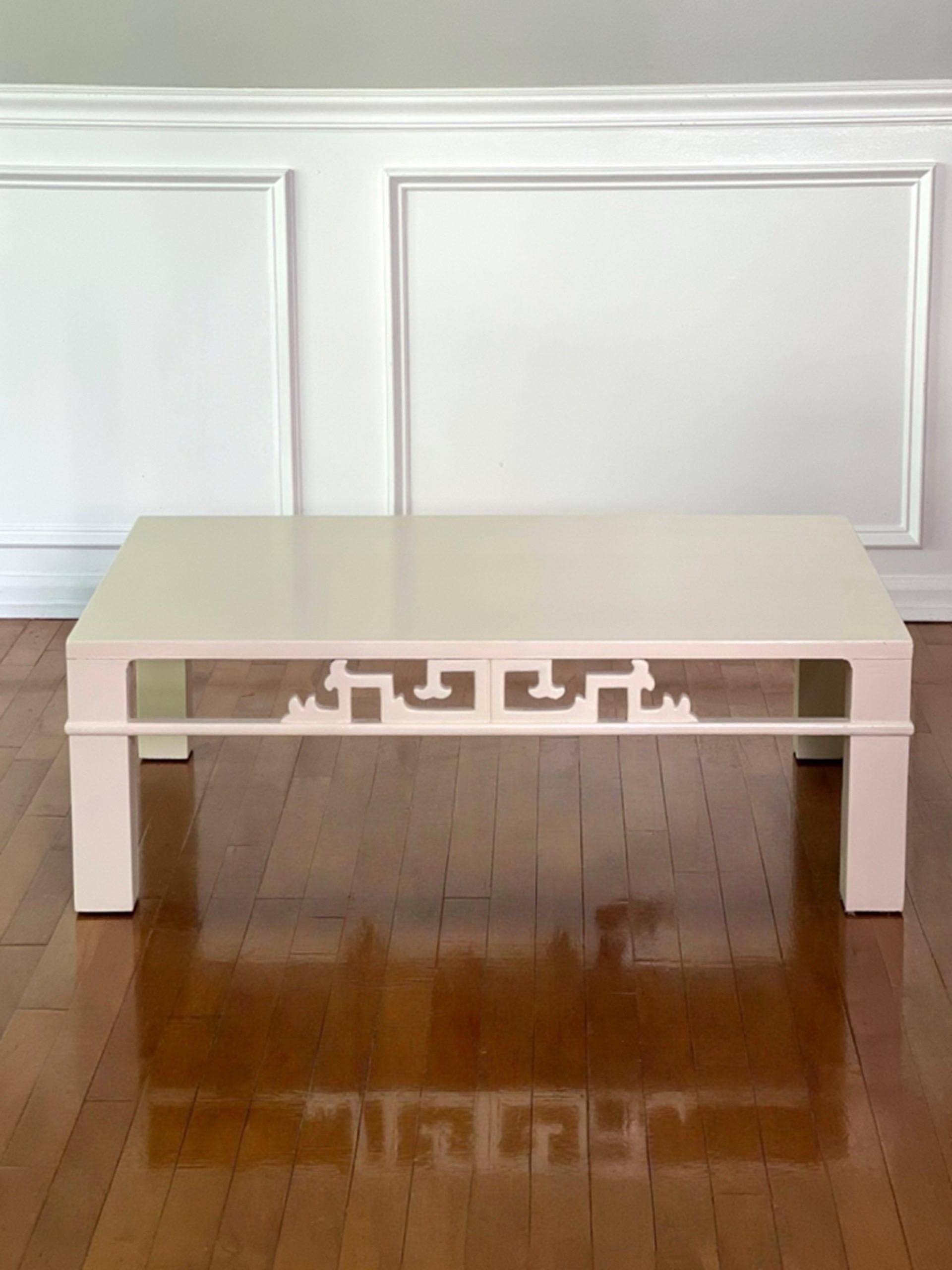 1970s Heritage-Henredon Asian style chinoiserie white coffee table.  Crisp, creamy white table with carved openwork along the apron raised on straight square legs.  Beautiful, clean lined table.