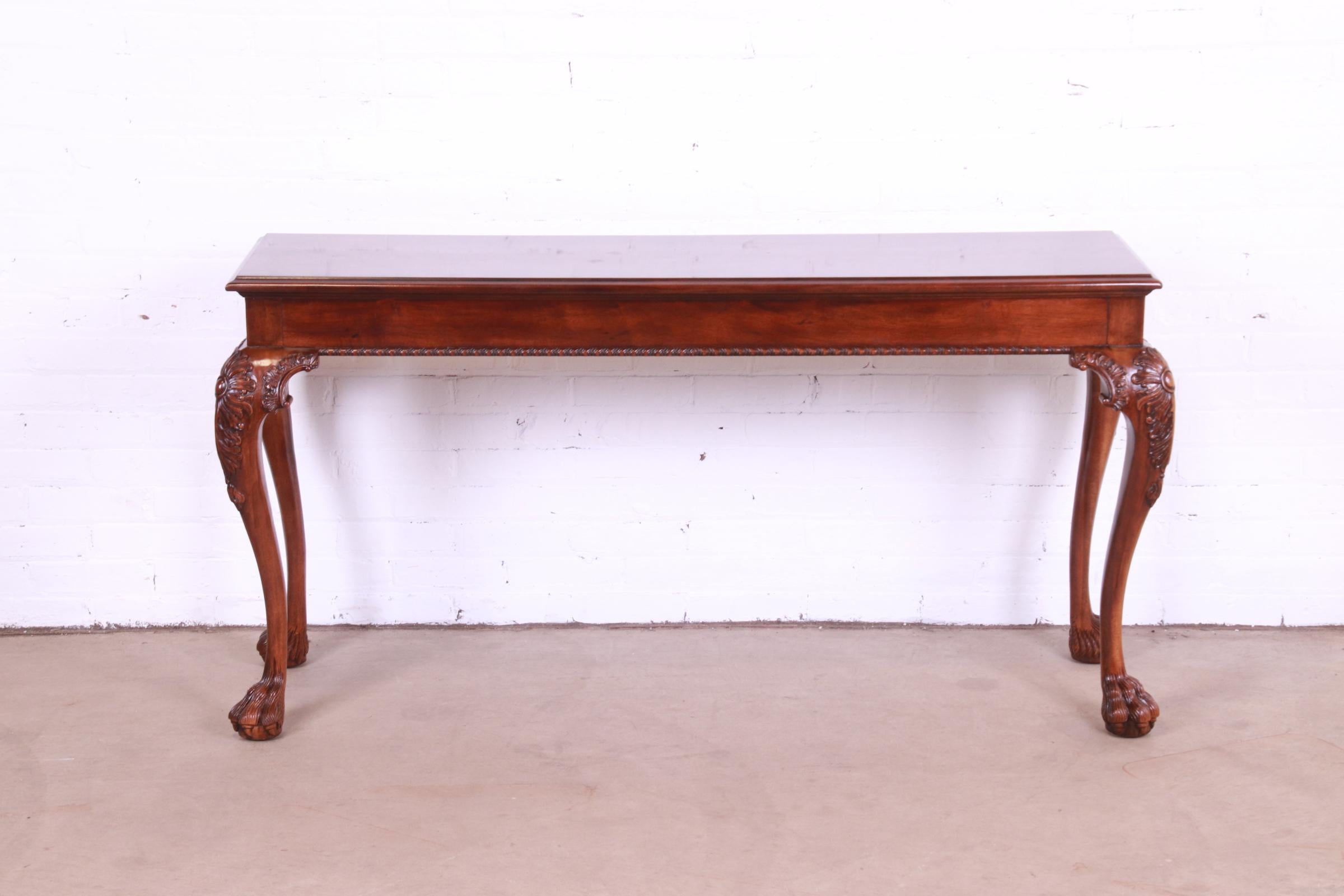 A gorgeous Chippendale or Georgian style console, hall table, or sofa table

By Henredon.

USA, Circa 1980s.

Carved mahogany, with burl wood top and hairy paw feet.

Measures: 59