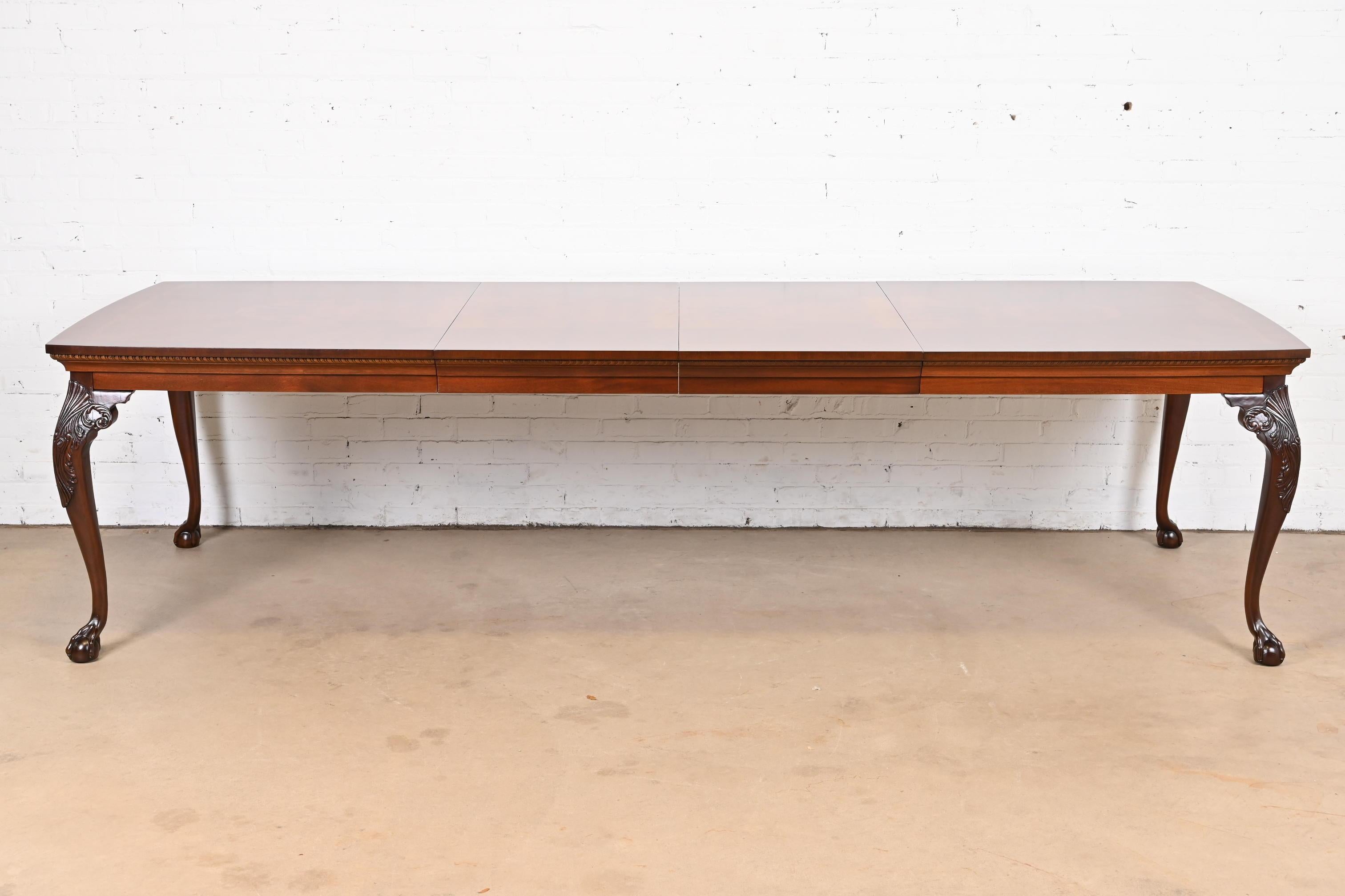An exceptional Chippendale or Georgian style extension dining table

By Henredon

USA, Circa 1980s

Gorgeous book-matched mahogany top, with burled walnut inlay, and carved solid mahogany legs with ball and claw feet.

Measures: 72