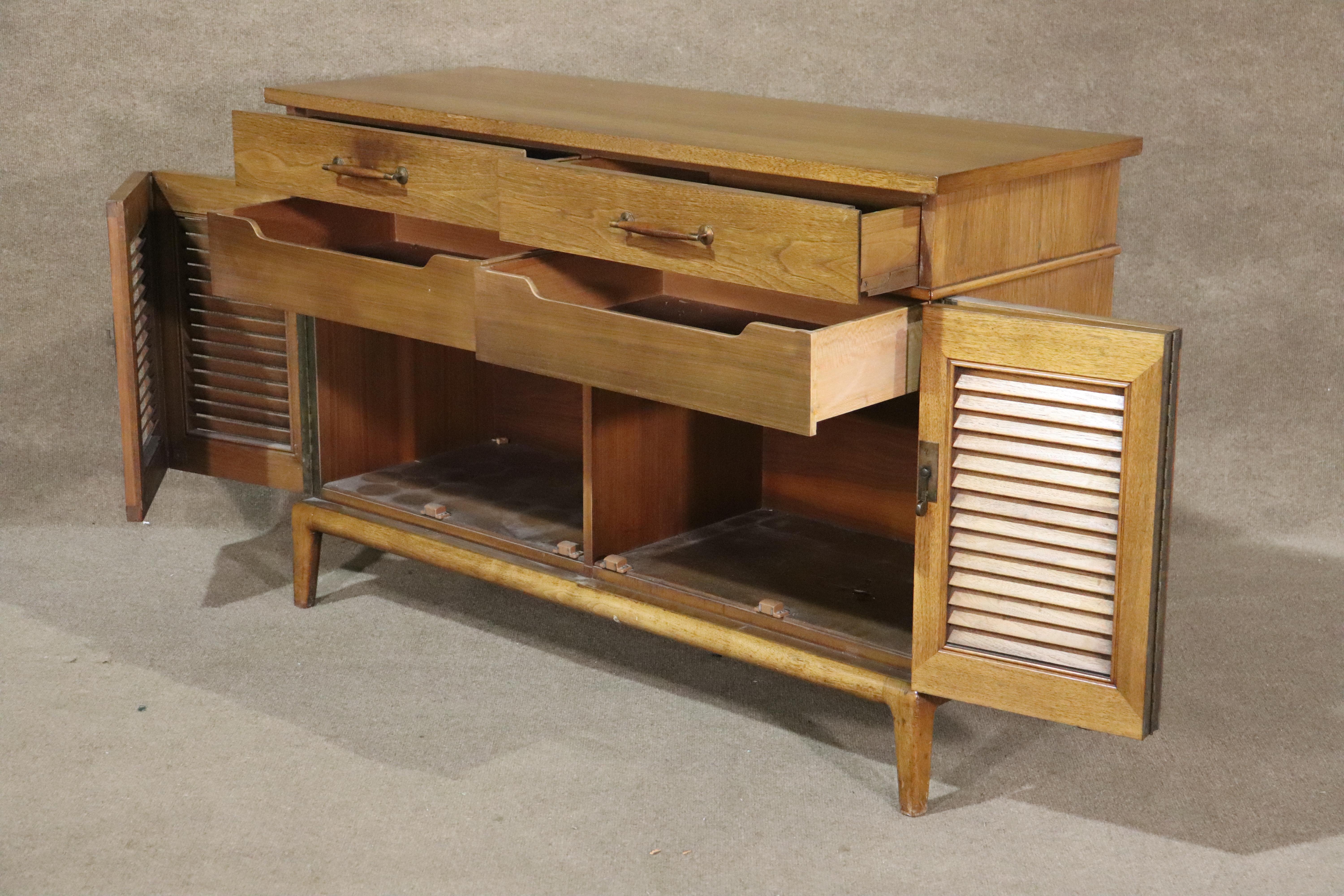 Low cabinet by Henredon for their 'Circa 60' line. Features louvered doors, four drawers, and drop down drawer option for serving.
Please confirm location NY or NJ