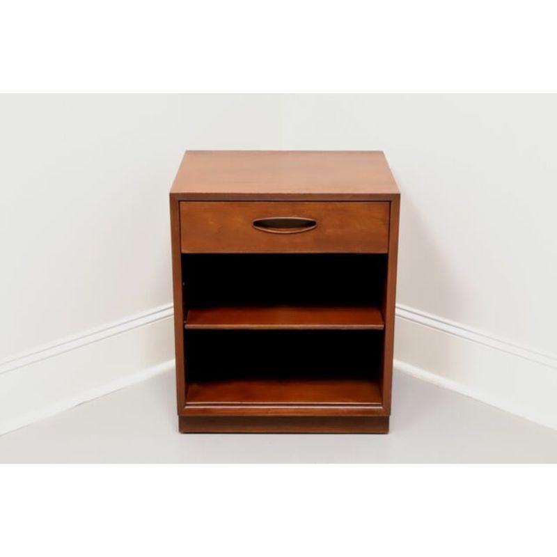 A Mid-Century Modern nightstand by Henredon, from their Circa '60 Collection. Walnut with inset ovoid pull. Features one dovetail drawer and open cabinet with one adjustable shelf. Has concealed 3-plug electrical cord and pre-drilled hole in back of