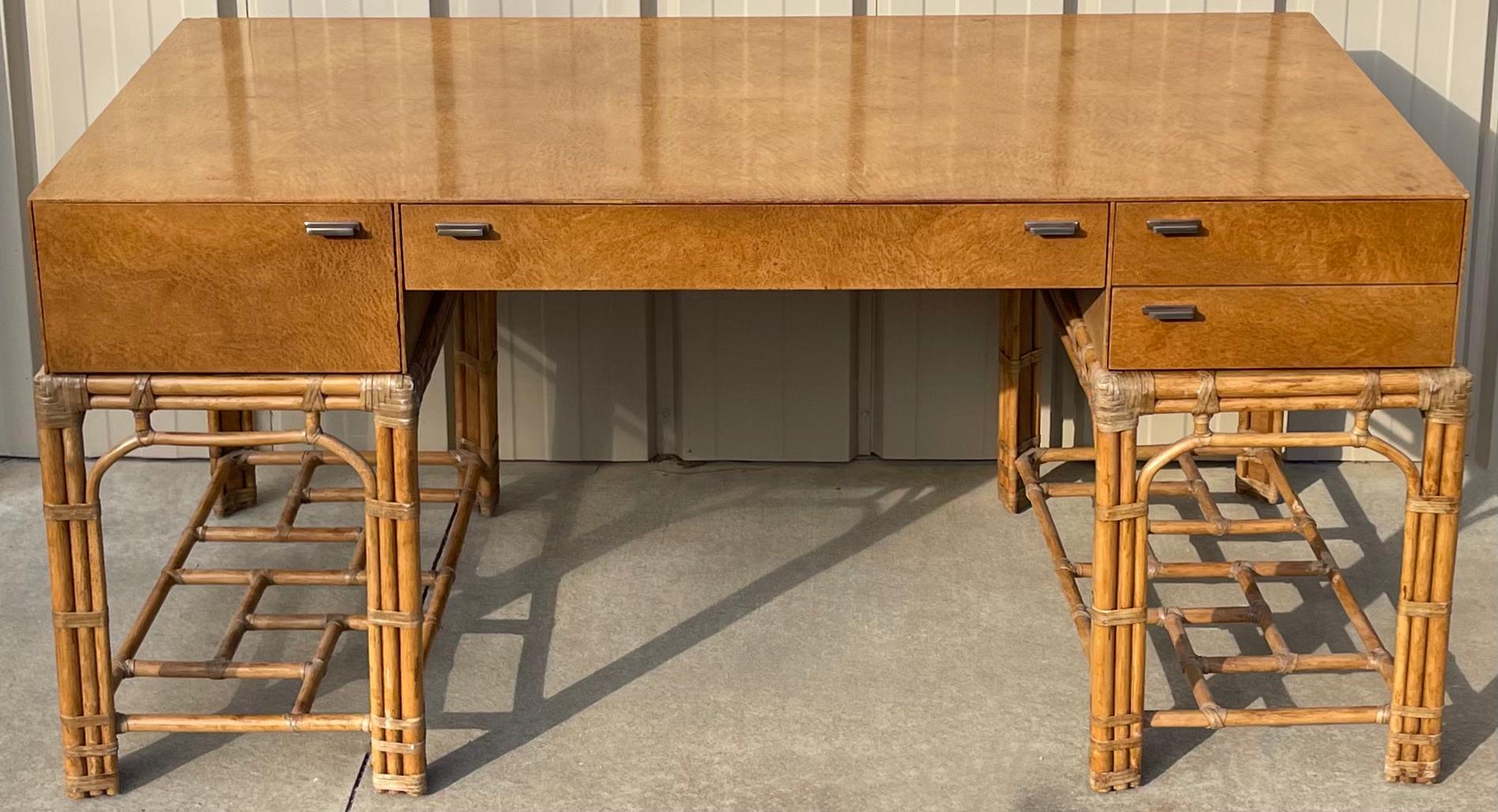 This is an excellent desk. It is a birdseye maple piece with double pedestal rattan base manufactured by Henredon as part of their Circa East Collection. The hardware is nickel, and it does breakdown into three pieces for ease of transportation.