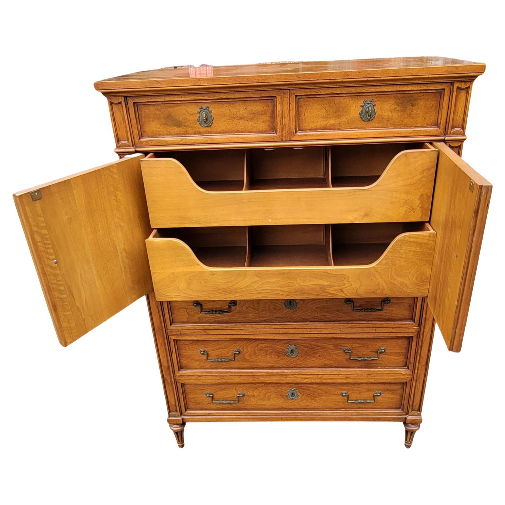 An Henredon custom Folio one fruitwood chest of drawers in very good vintage condition. Features 2 smaller top drawers, a two door cabinet and 3 large bottom drawers. 
Measures 40