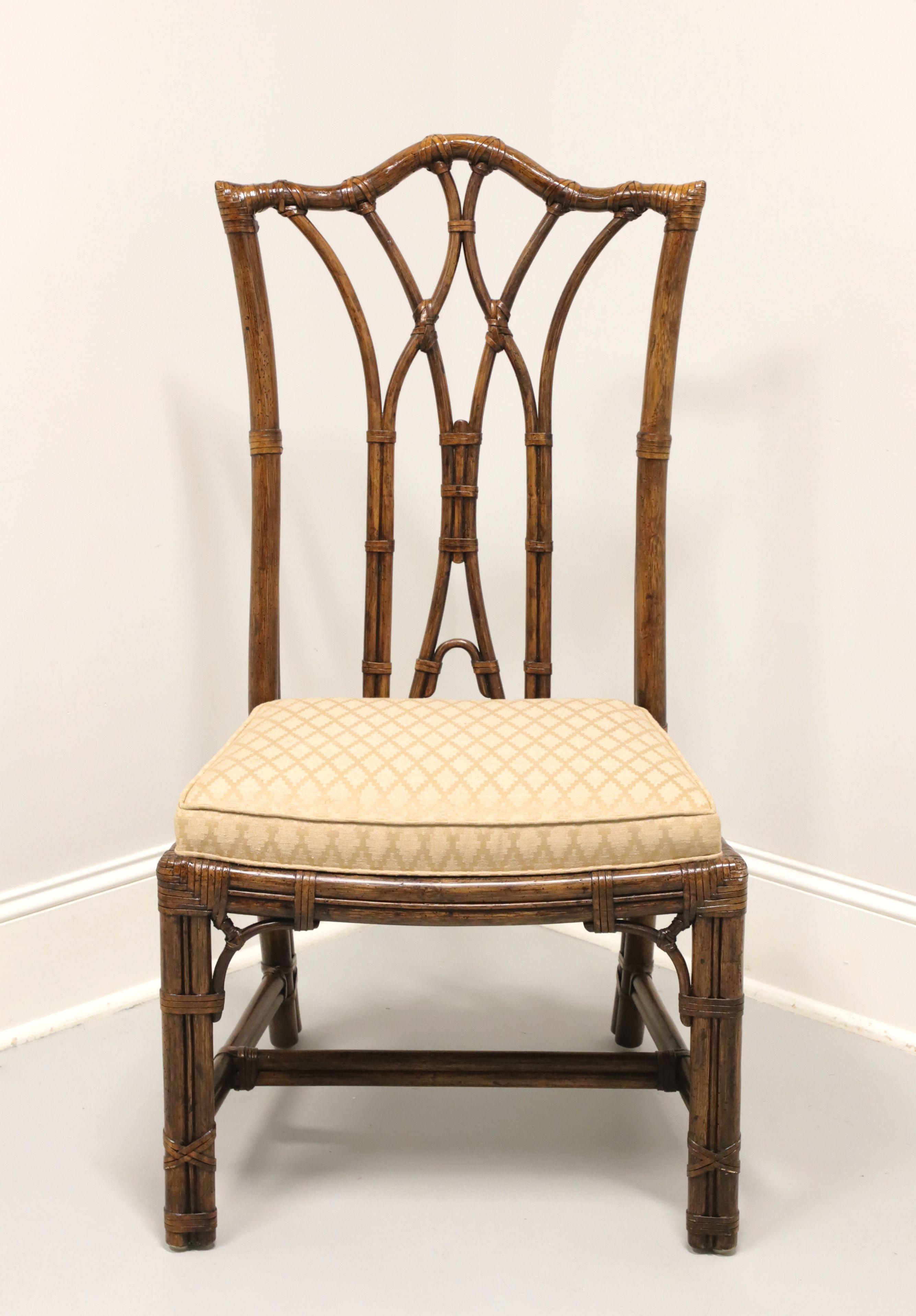 A Chinese Chippendale style side chair by Henredon. Faux bamboo frame with rattan strapping, high back, arched crestrail, decorative back rest, beige & gold color diamond pattern fabric upholstered seat, lattice accents to corners under apron,
