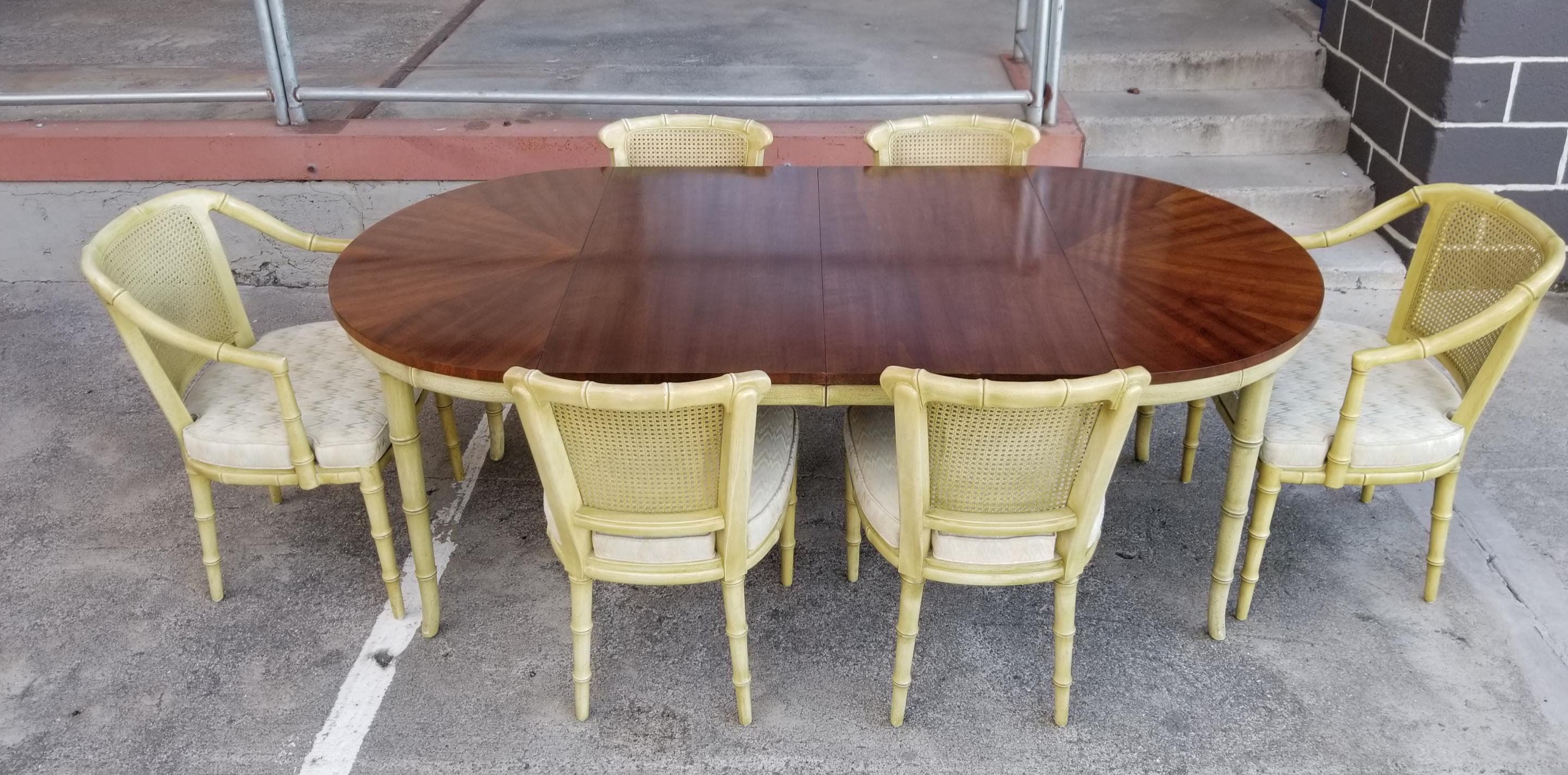 A fine quality seven piece dining set by Henredon Furniture. Faux bamboo design with original celadon or spring green painted finish. Beautiful fanned and book-matched walnut table top with two 20