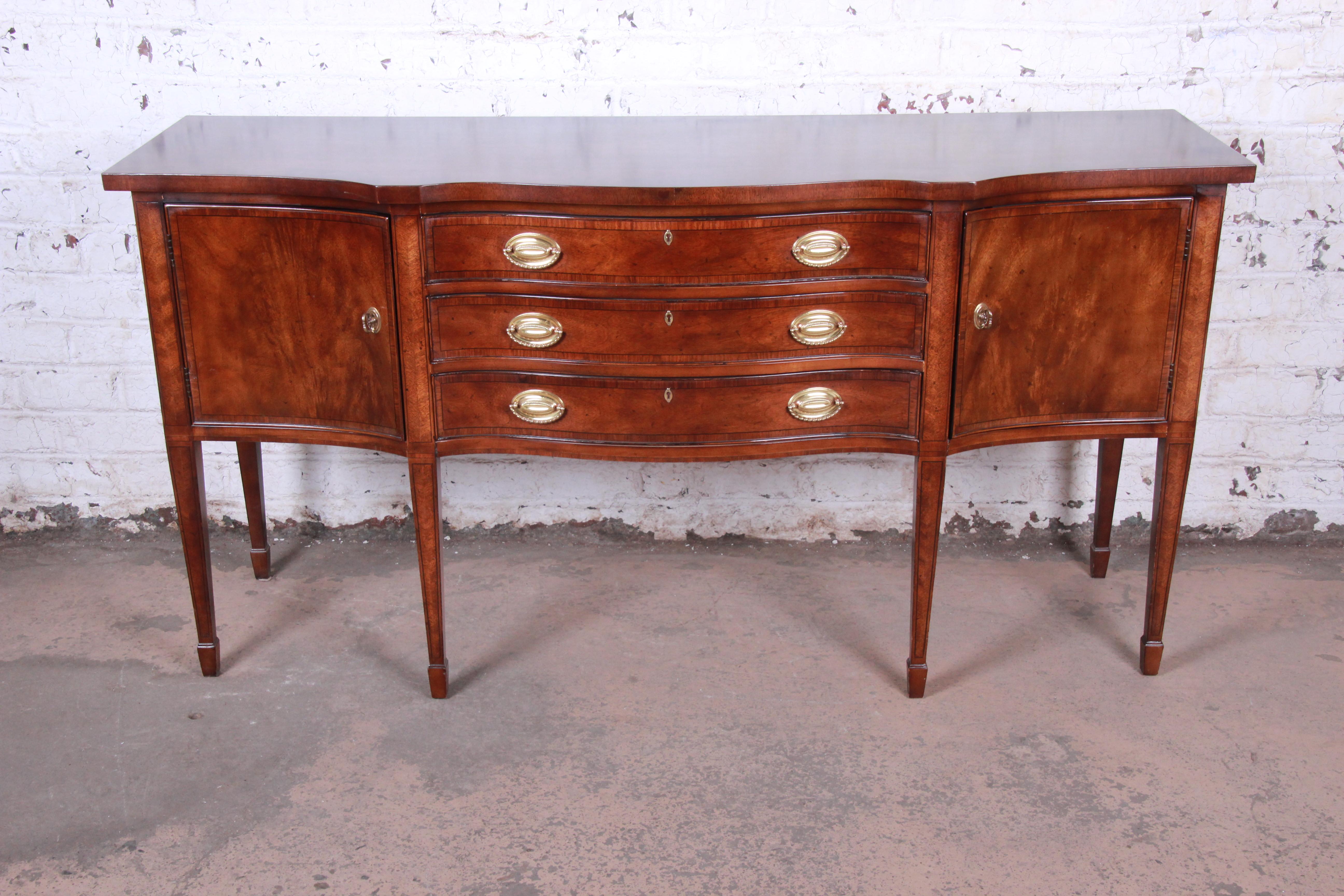 An exceptional banded inlaid flame mahogany Federal style sideboard credenza or bar server

By Henredon 