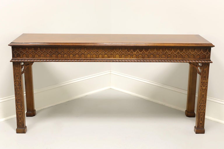 A Chinese Chippendale style sofa table by Henredon. Solid mahogany, banded flame mahogany to top, decorative carved fretwork with beaded edge to apron, straight legs with decorative fretwork and block feet. Made in Morganton, North Carolina, USA, in