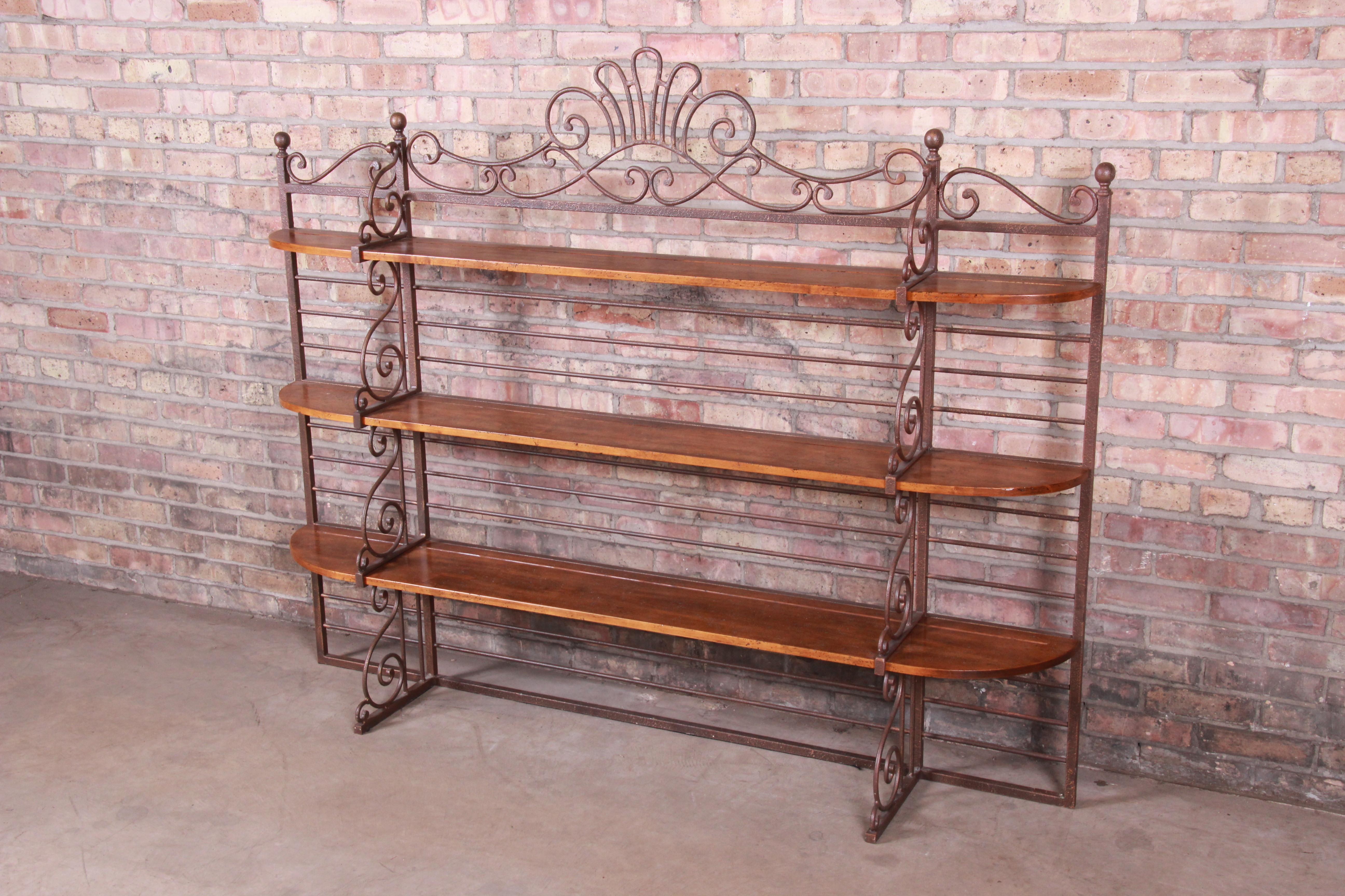 A gorgeous French country baker's rack or étagère

By Henredon Fine Furniture

USA, circa 1990s

Iron frame, with fruitwood shelving.

Measures: 70