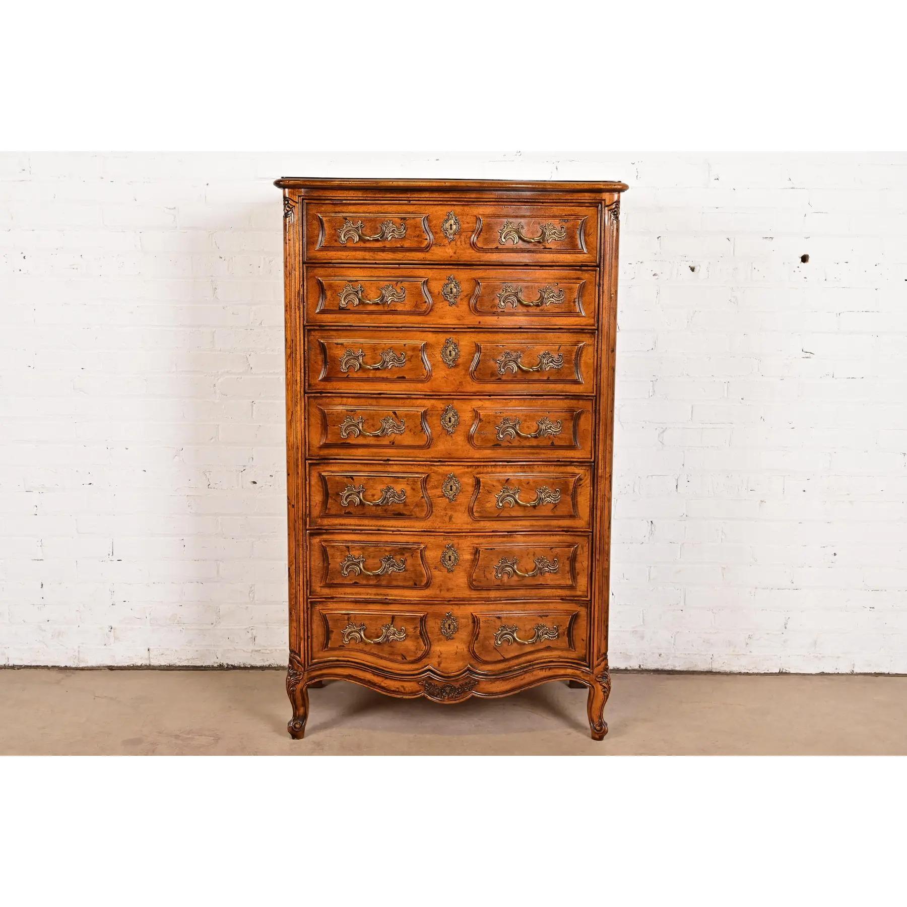 A gorgeous French Provincial Louis XV style semainier, lingerie chest, or highboy dresser

By Henredon

USA, Late 20th Century

Beautiful carved solid walnut, with original brass hardware

Measures: 34