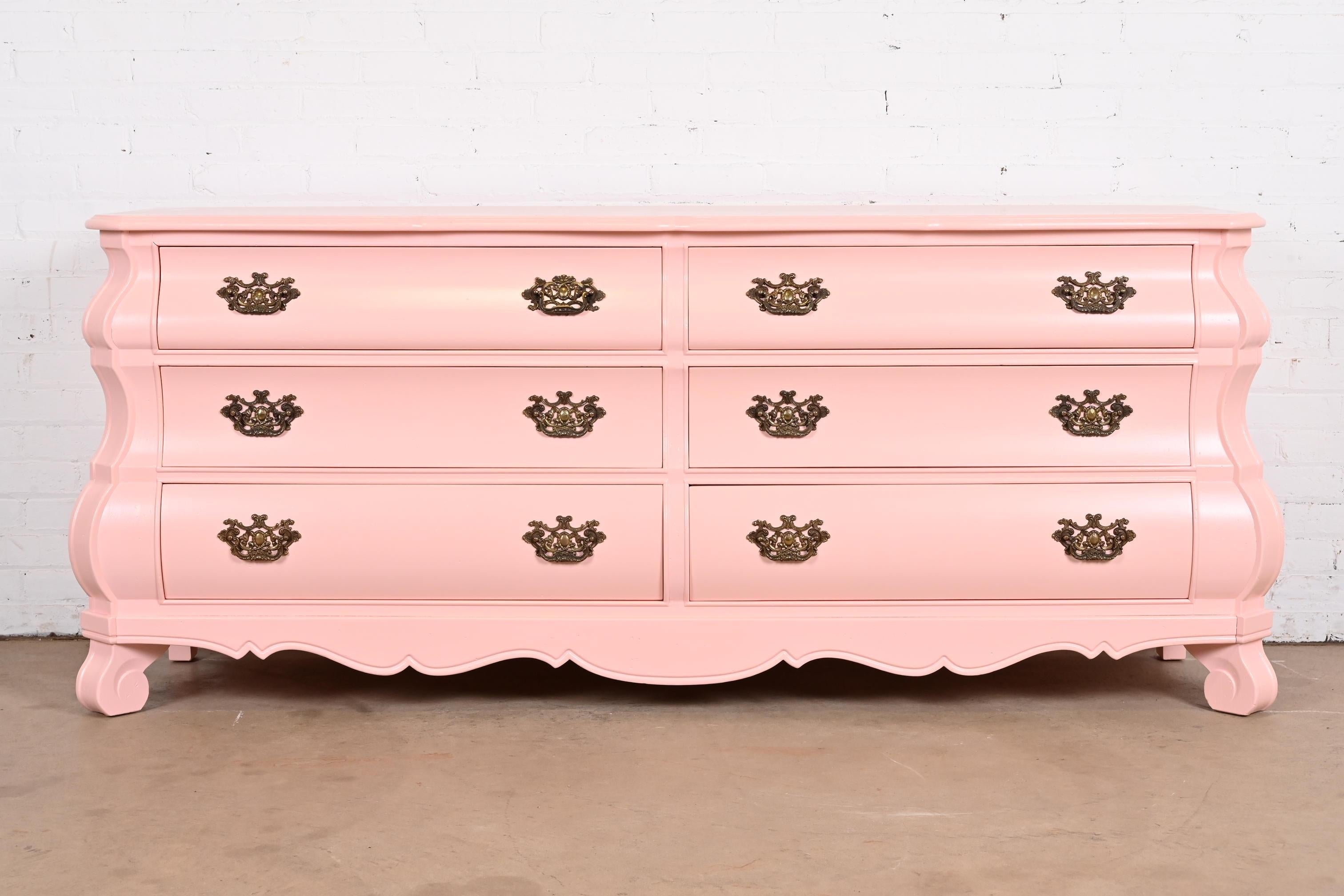 A gorgeous French Provincial or Dutch Louis XV style six-drawer Bombay form dresser or credenza

By Henredon

USA, Circa 1960s

Pink lacquered solid cherry wood, with original brass hardware.

Measures: 77.5