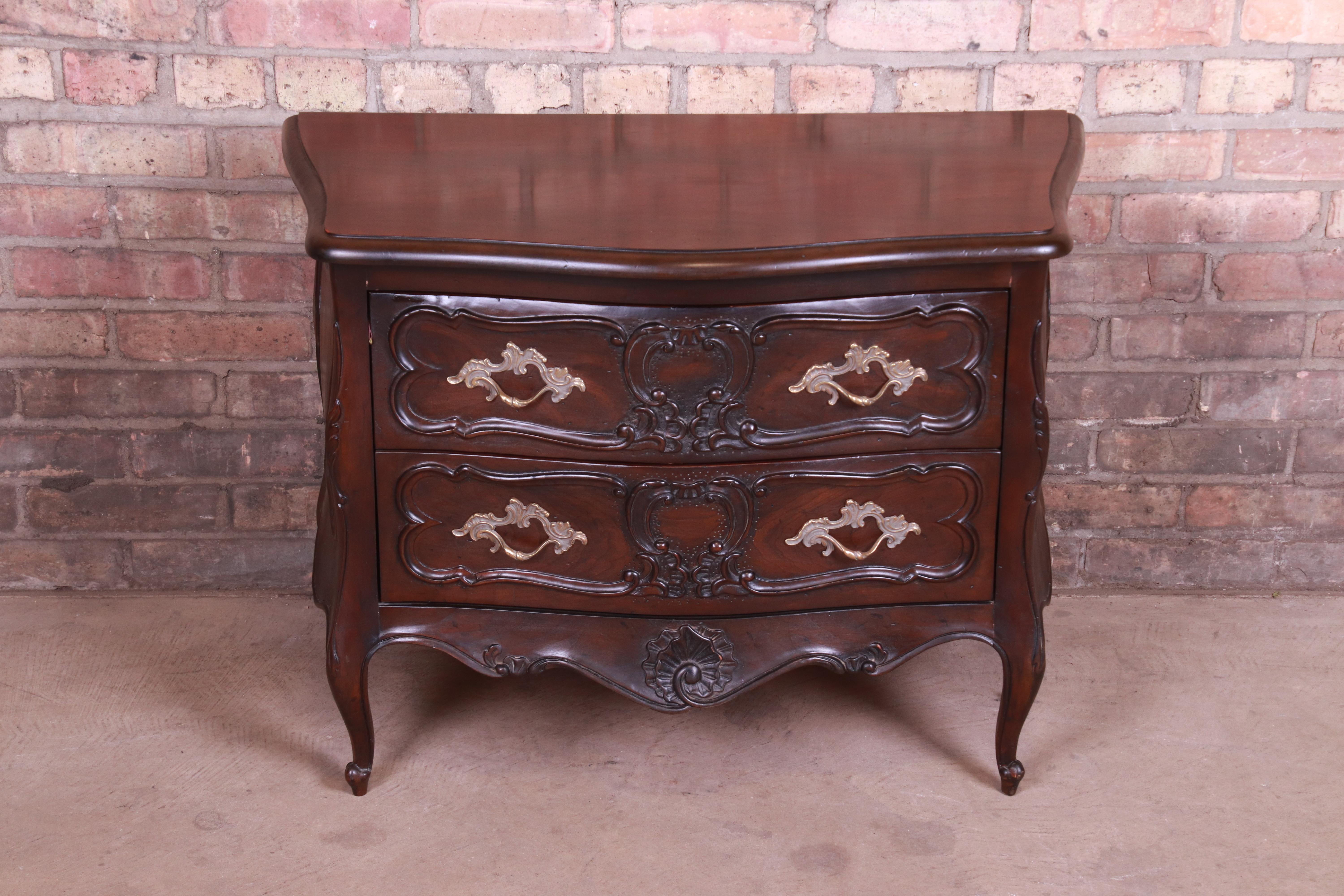 A gorgeous French Provincial Louis XV style Bombay chest or commode

By Henredon

USA, late 20th century

Carved walnut, with original brass hardware.

Measures: 32