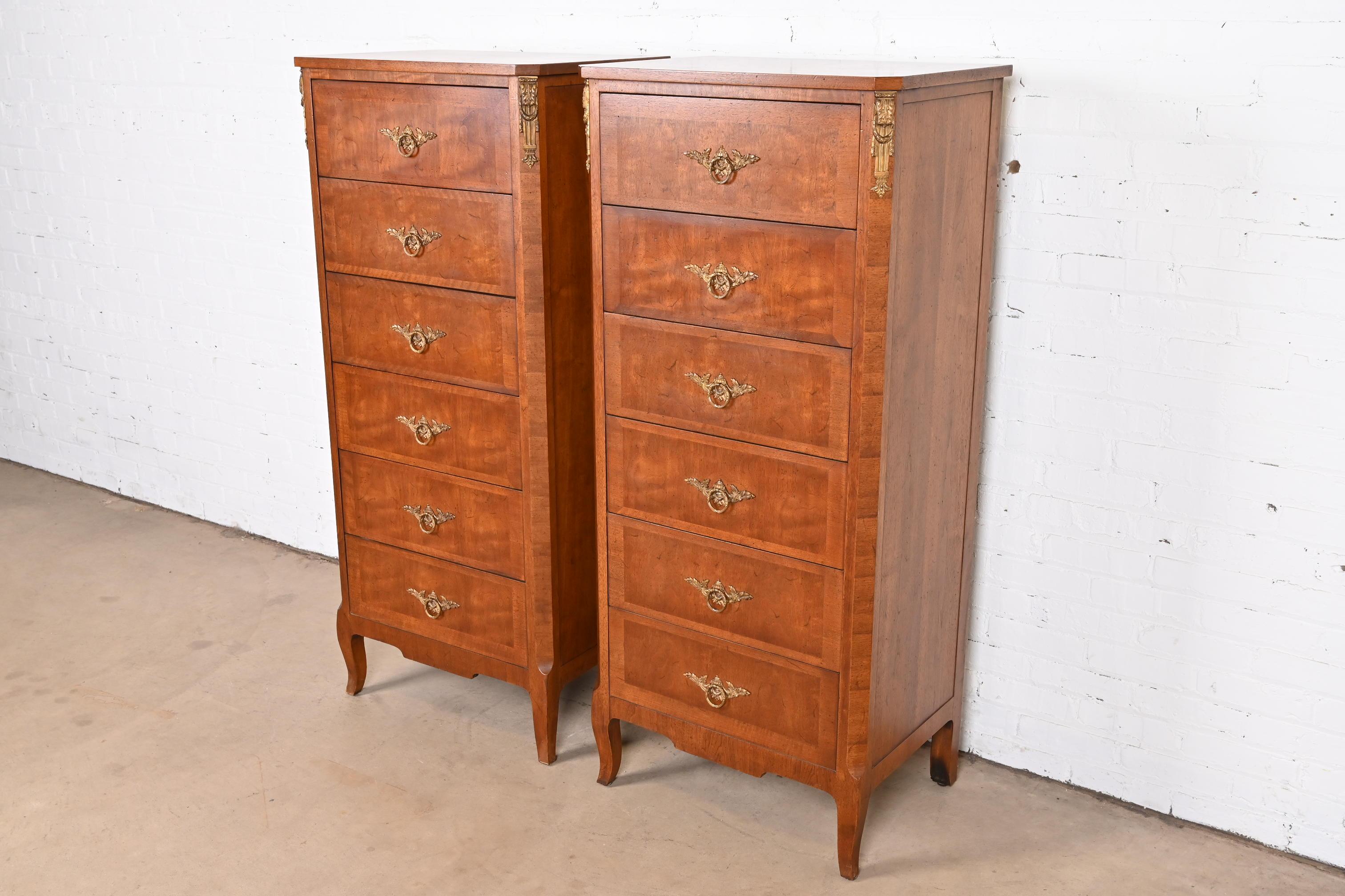 A gorgeous pair of French Provincial Louis XV style six-drawer highboy dressers or lingerie chests

By Henredon

USA, circa 1960s

Carved banded walnut, with bronze ormolu mounts, and original brass hardware.

Measures: 25