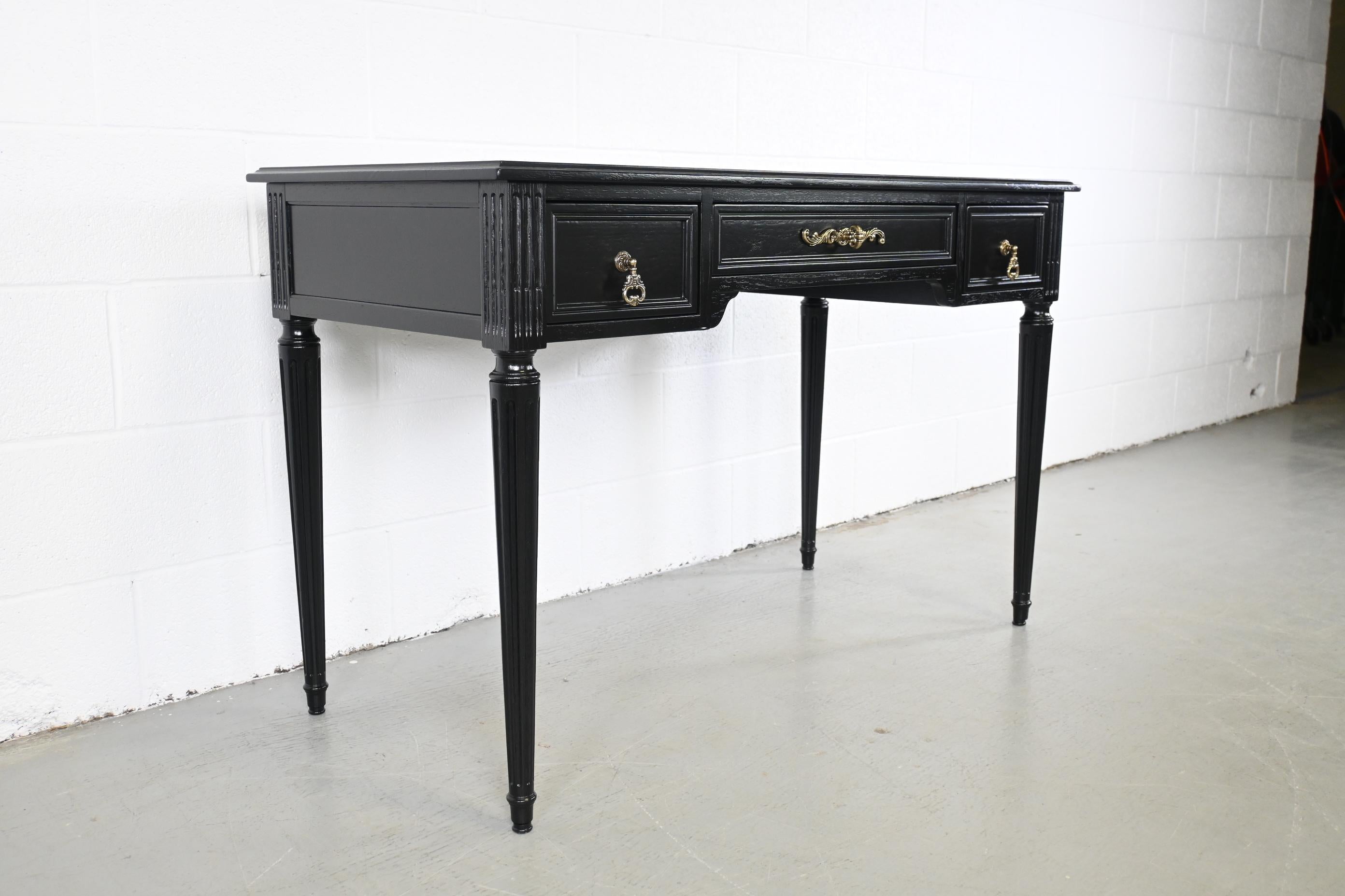 Henredon Furniture French Regency Style Black Lacquered Writing Desk

Henredon Furniture, USA, 1980s

46.5 Wide x 22 Deep x 30 High

French Regency style black lacquered desk with three drawers and brass hardware. 

Professionally