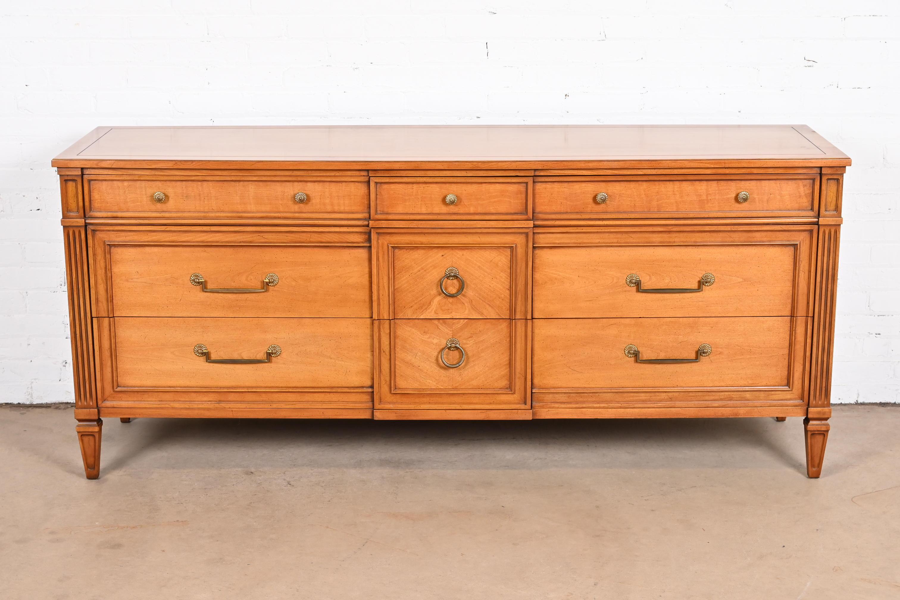 A gorgeous French Regency Louis XV style nine-drawer long dresser or credenza

By Henredon

USA, circa 1960s

Carved cherry wood, with original brass hardware.

Measures: 74