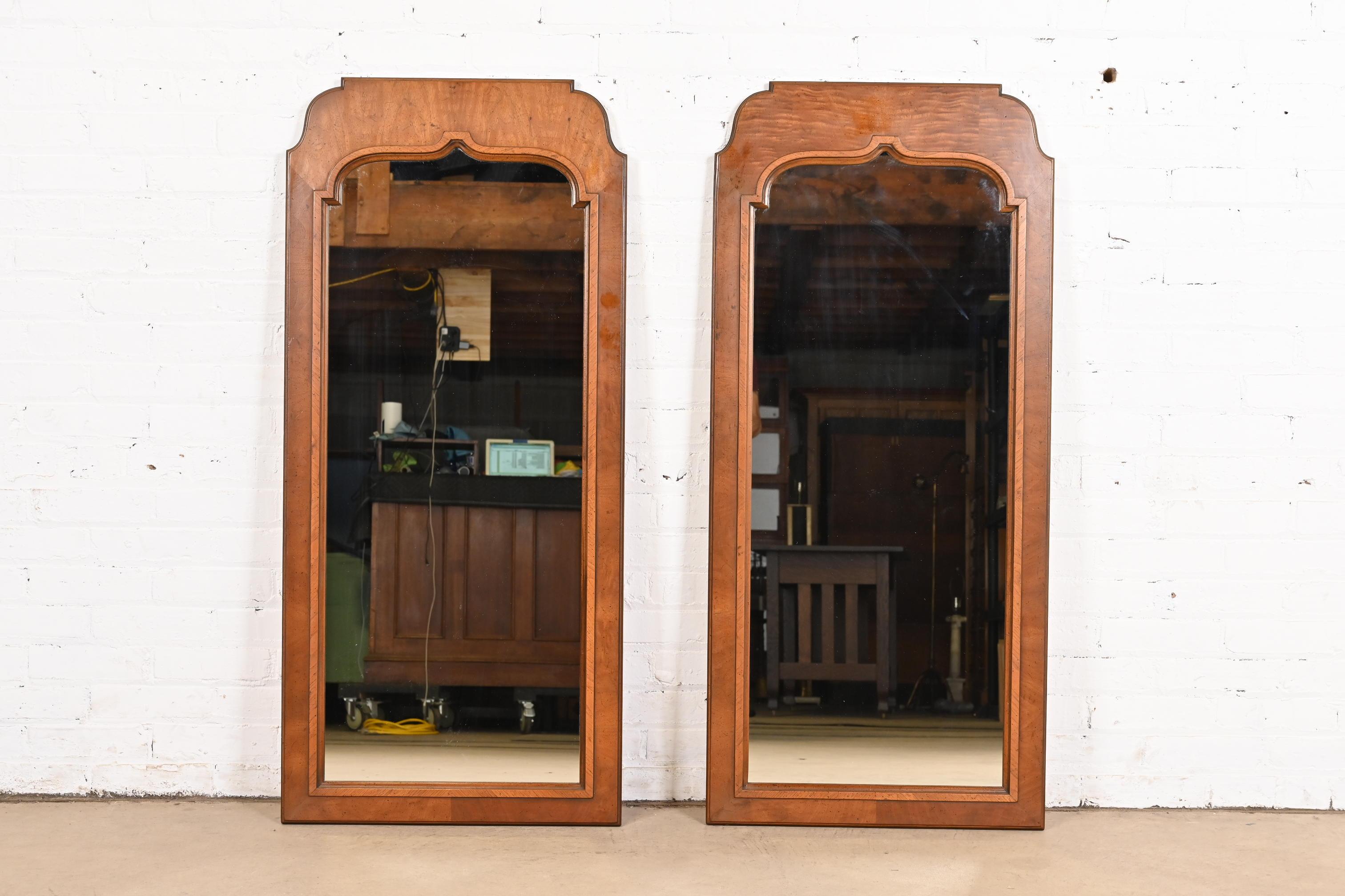 A gorgeous pair of French Regency Louis XVI style carved walnut tall wall mirrors

By Henredon

USA, Circa 1970s

Measures: 22
