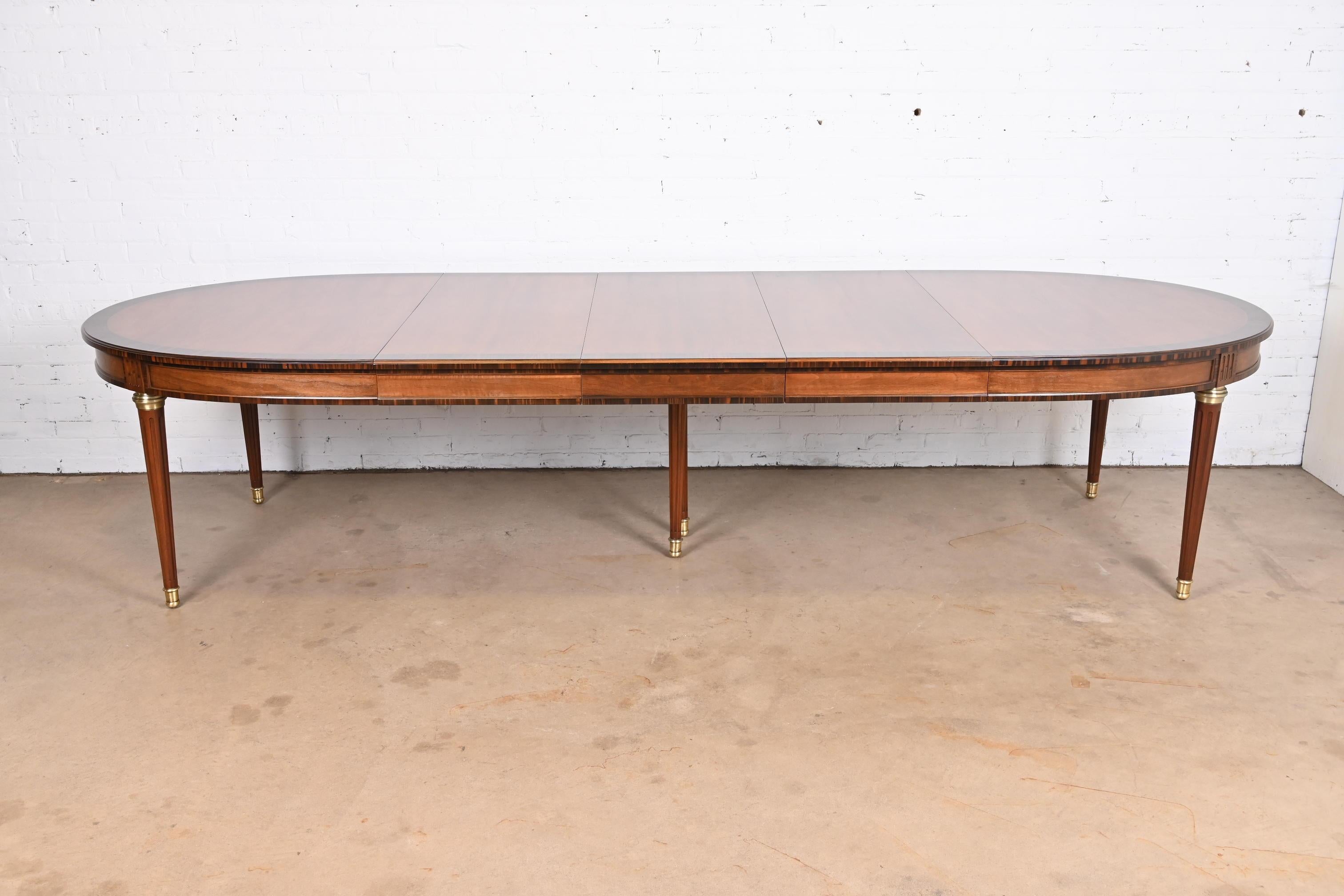 A gorgeous French Regency Louis XVI style extension dining table

By Henredon

USA, Late 20th Century

Book-matched cherry wood, with stunning Macassar ebony banding, brass accents, and brass sabots.

Measures: 72