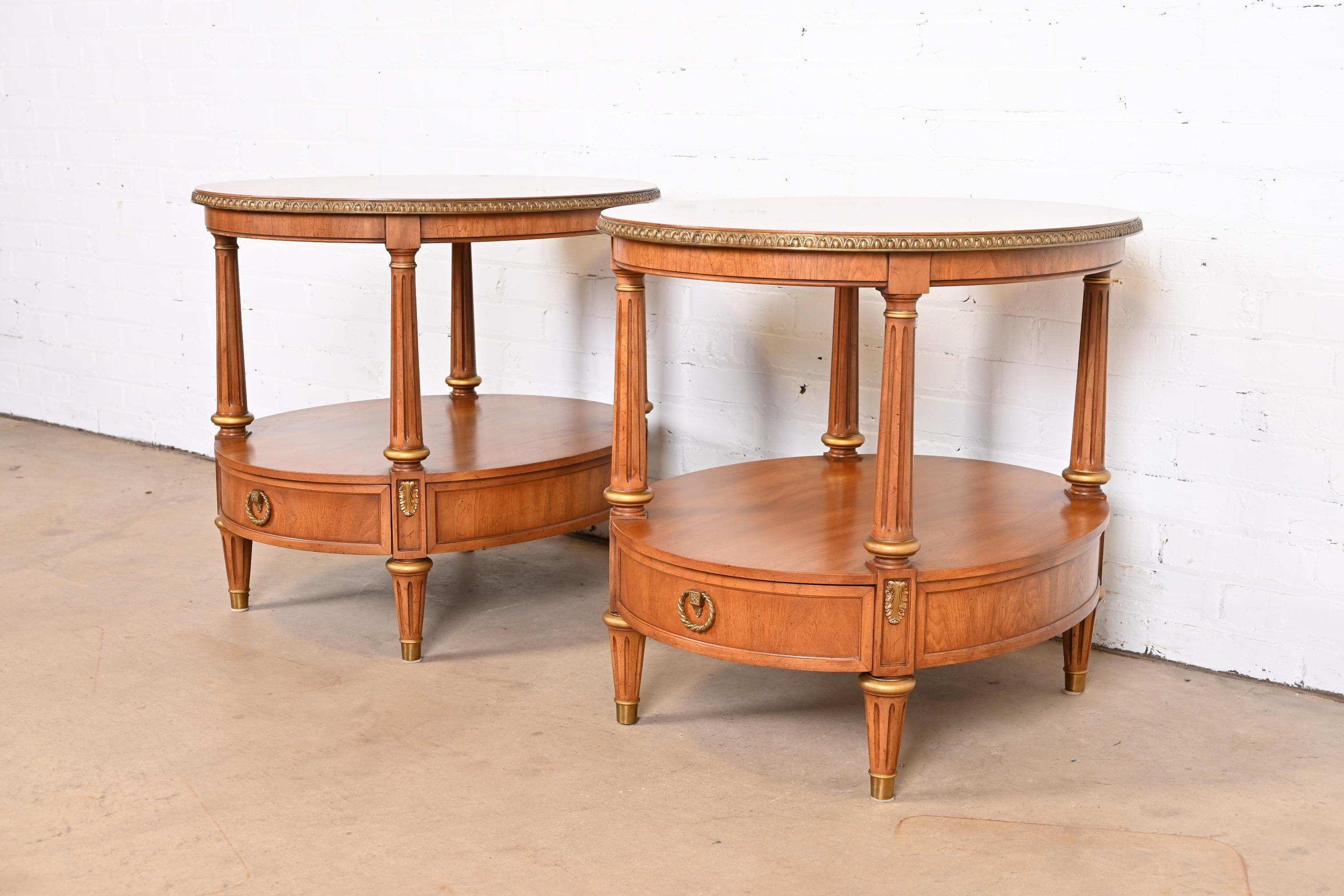 A gorgeous pair of French Regency Louis XVI style nightstands or side tables

By Henredon

USA, Circa 1970s

Carved fruitwood, with gold gilt trim and accents and original brass hardware.

Measures: 24.25