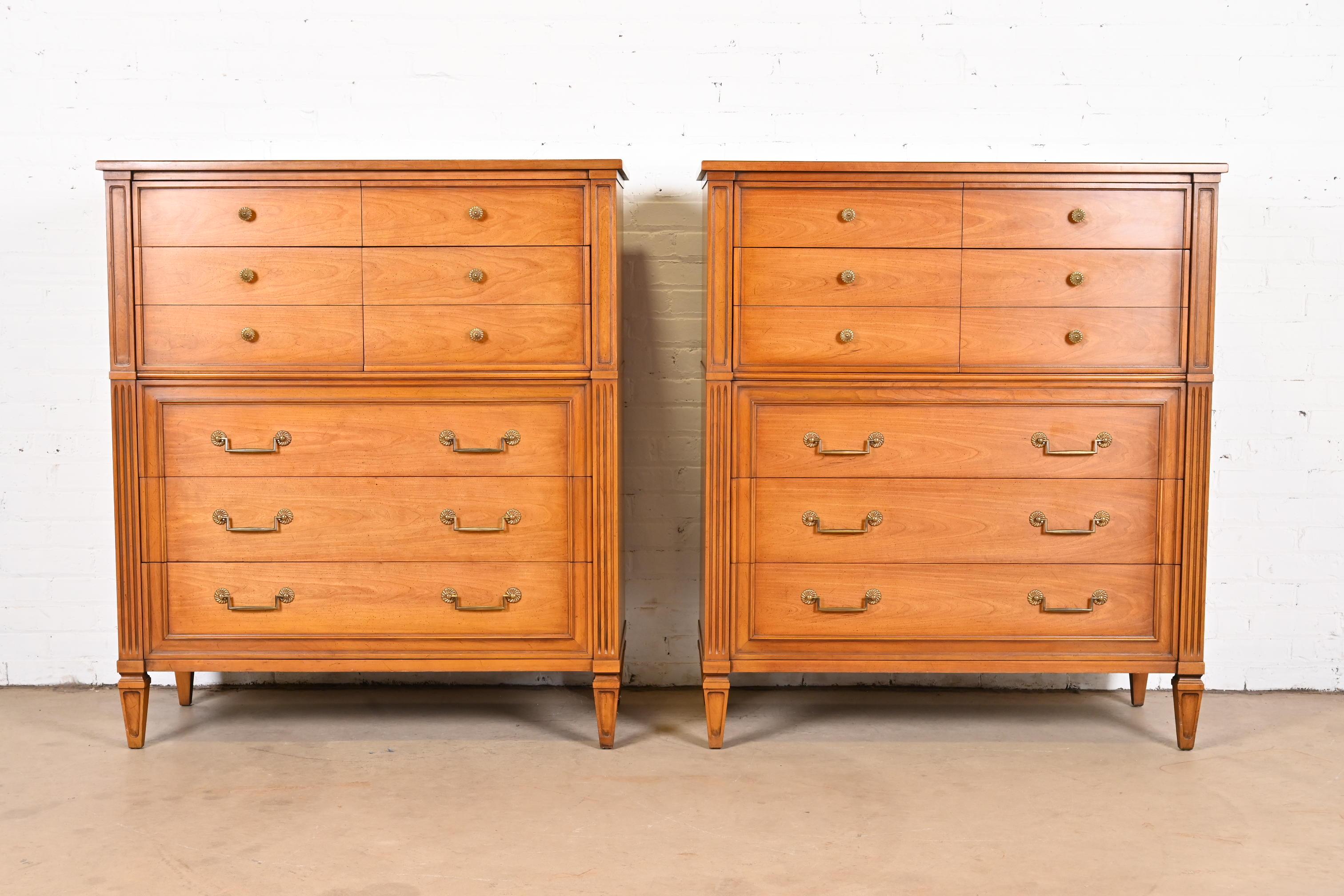 A gorgeous pair of French Regency Louis XVI style highboy dressers

By Henredon

USA, circa 1960s

Carved fruitwood, with original brass hardware.

Each measures: 42