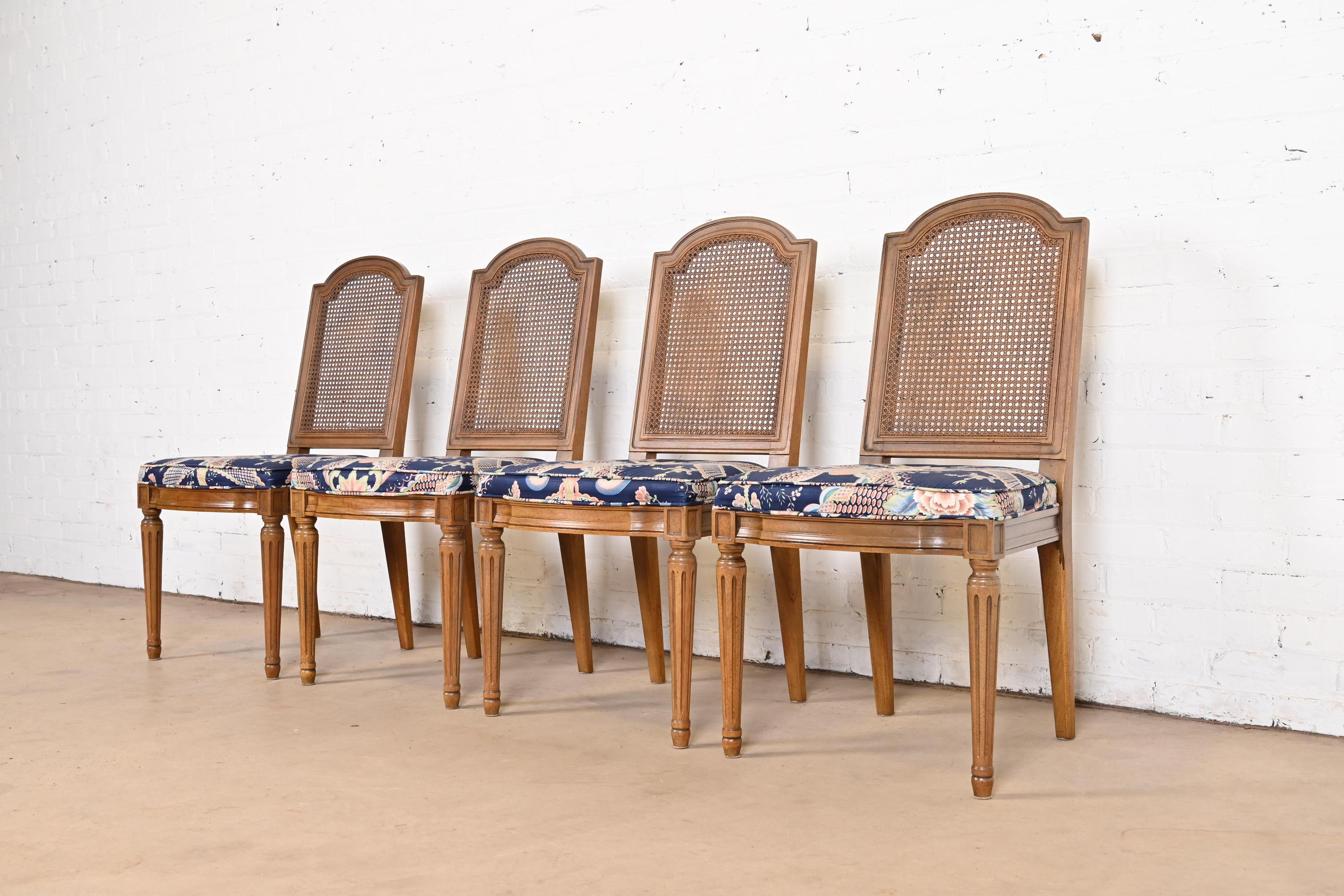 A gorgeous set of four French Regency Louis XVI style dining chairs

By Henredon

USA, Circa 1960s

Sculpted walnut frames, with caned seat backs, and floral patterned upholstered seats.

Measures: 19.5