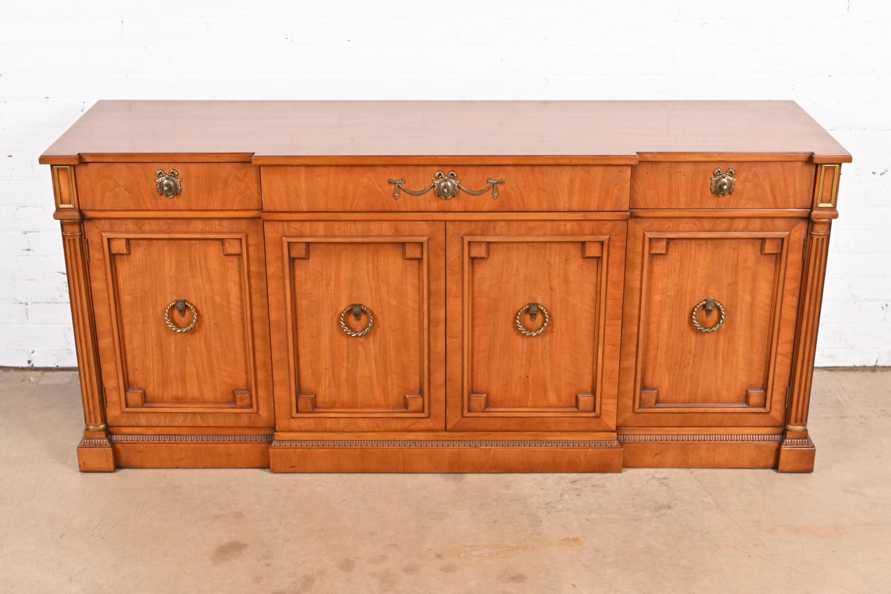 A gorgeous French Regency Louis XVI style sideboard, credenza, or bar cabinet

By Henredon

USA, Circa 1960s

Carved walnut, with gold gilt accents and original brass hardware.

Measures: 68