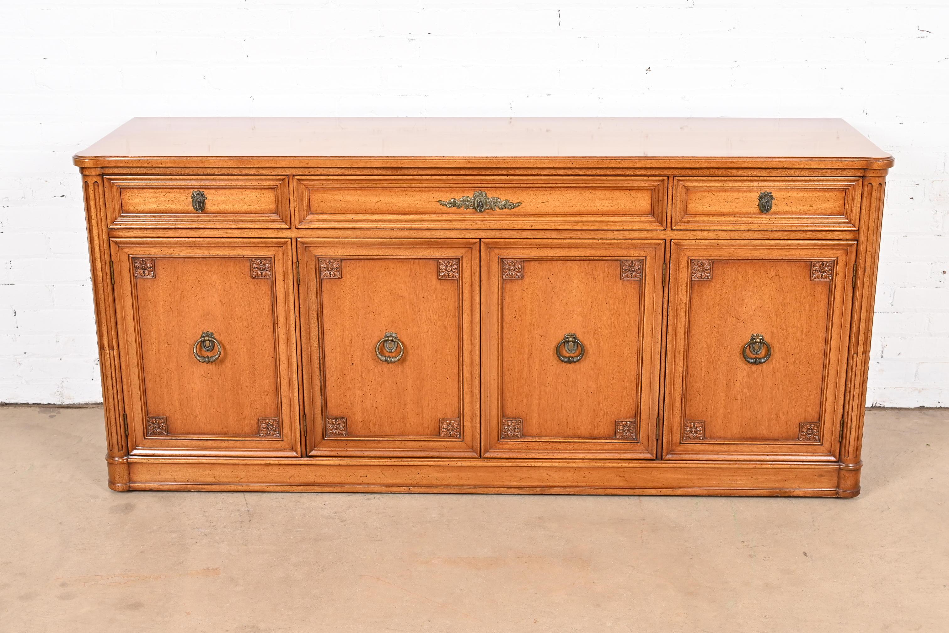 A gorgeous French Regency Louis XVI style sideboard, credenza, or bar cabinet

By Henredon

USA, Circa 1960s

Carved walnut, with original brass hardware.

Measures: 68