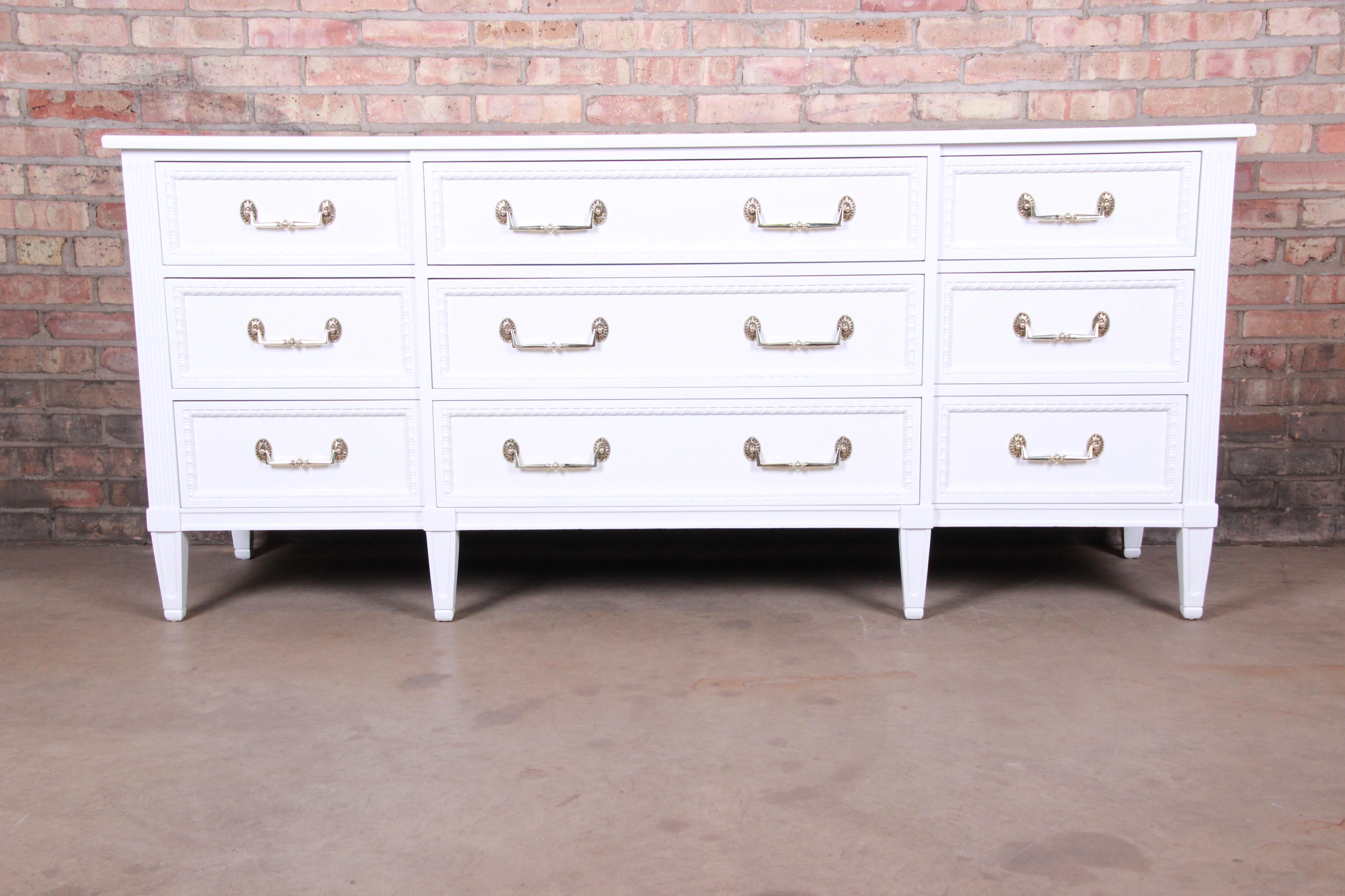 A gorgeous French Regency Louis XVI style long dresser or credenza

By Henredon

USA, circa 1960s

White lacquered walnut, with original brass hardware.

Measures: 71.75